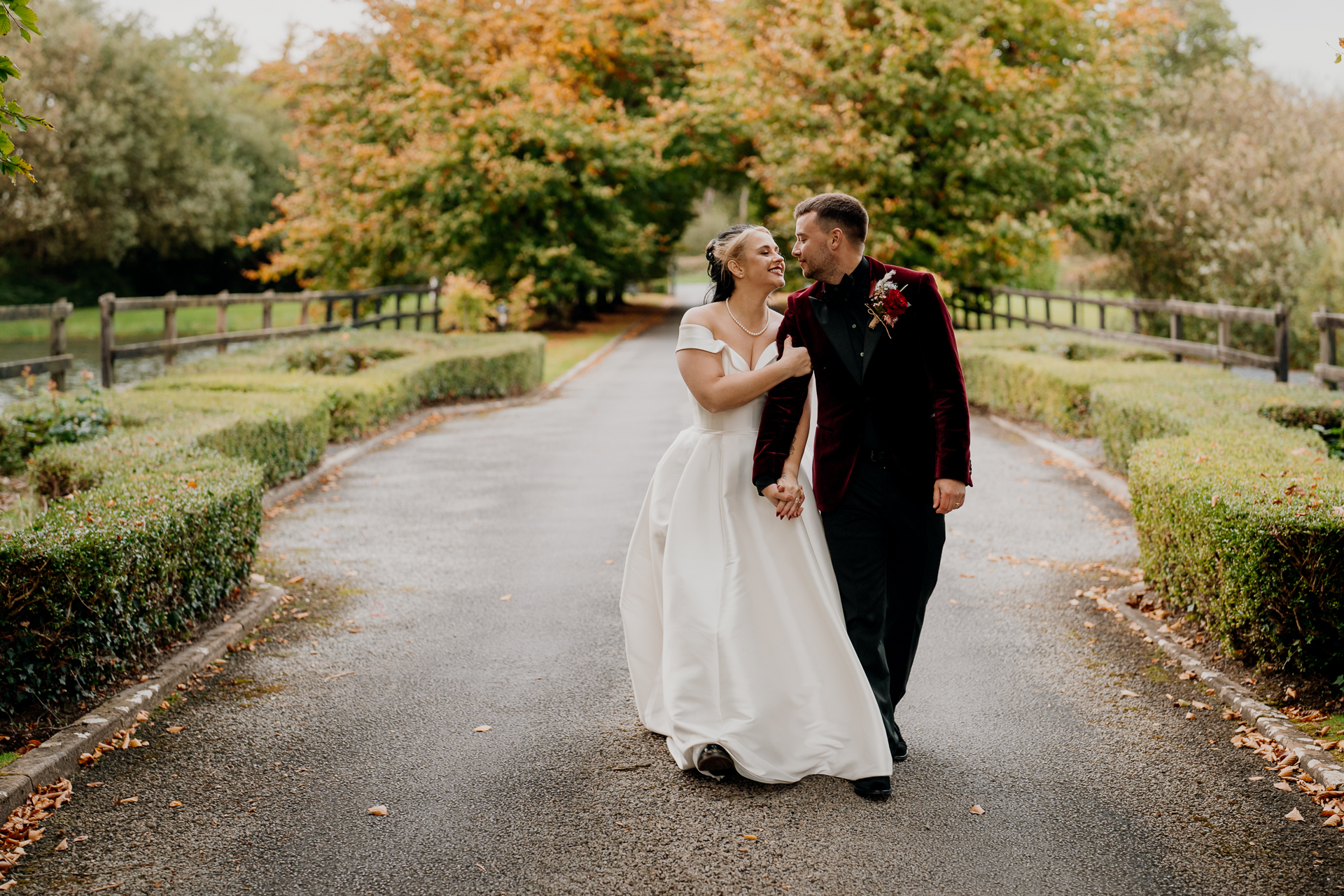 A man and woman walking down a road