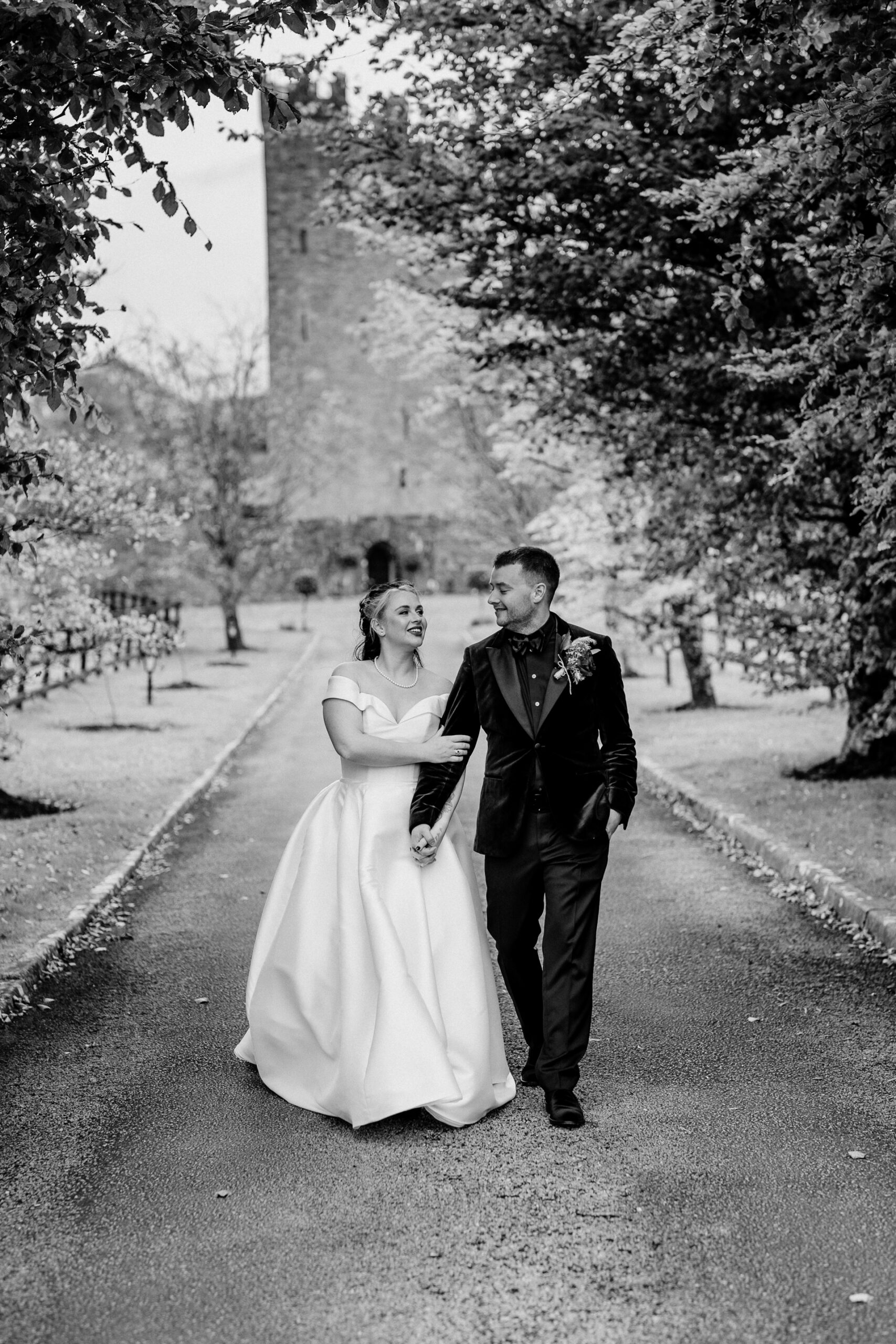 A man and woman walking down a road