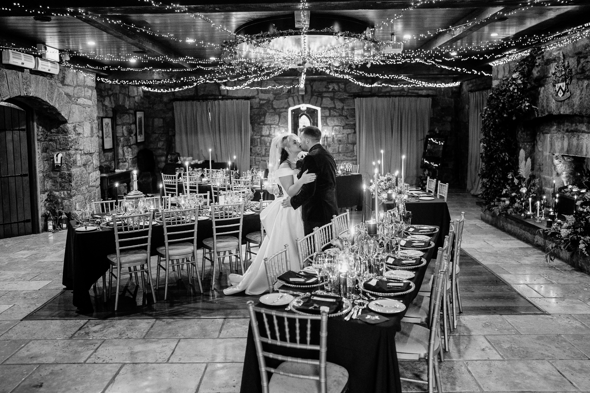 A couple standing in a room with tables and chairs