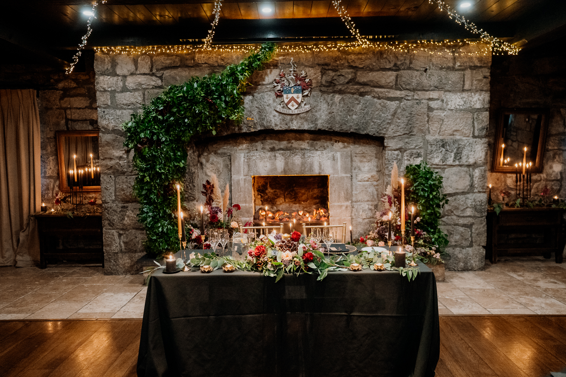 A fireplace with flowers and candles