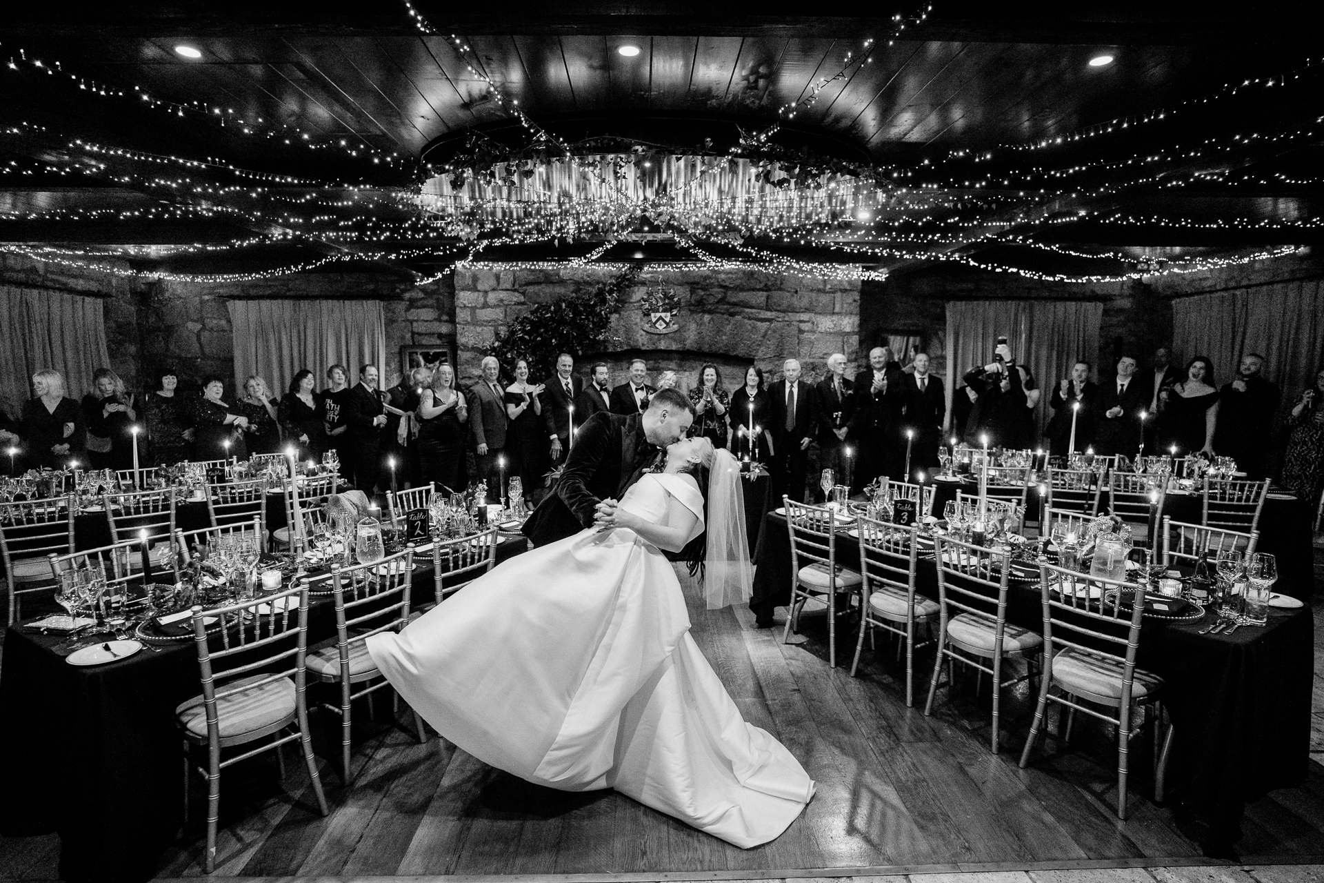 A person in a tutu in a room full of tables and chairs