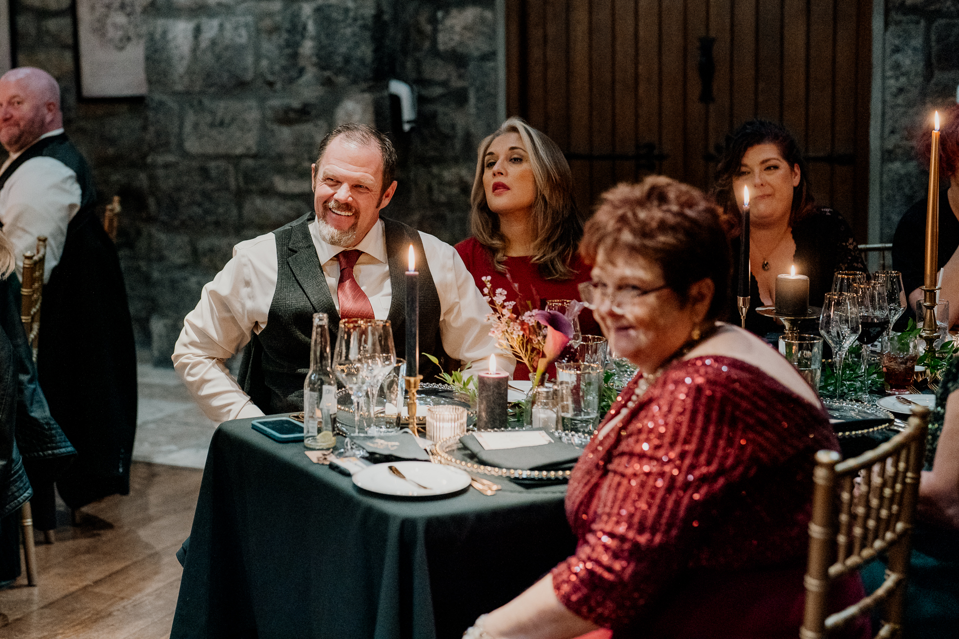 A group of people sitting around a table with food and drinks