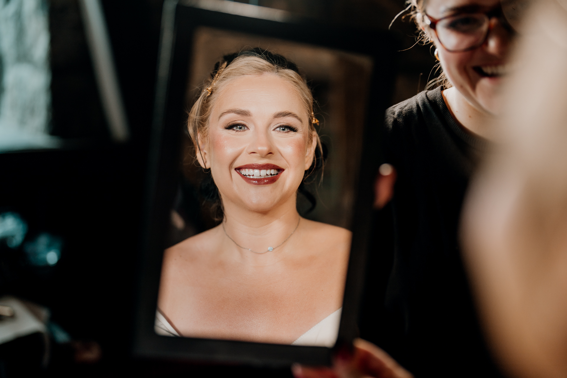 A woman smiling next to another woman