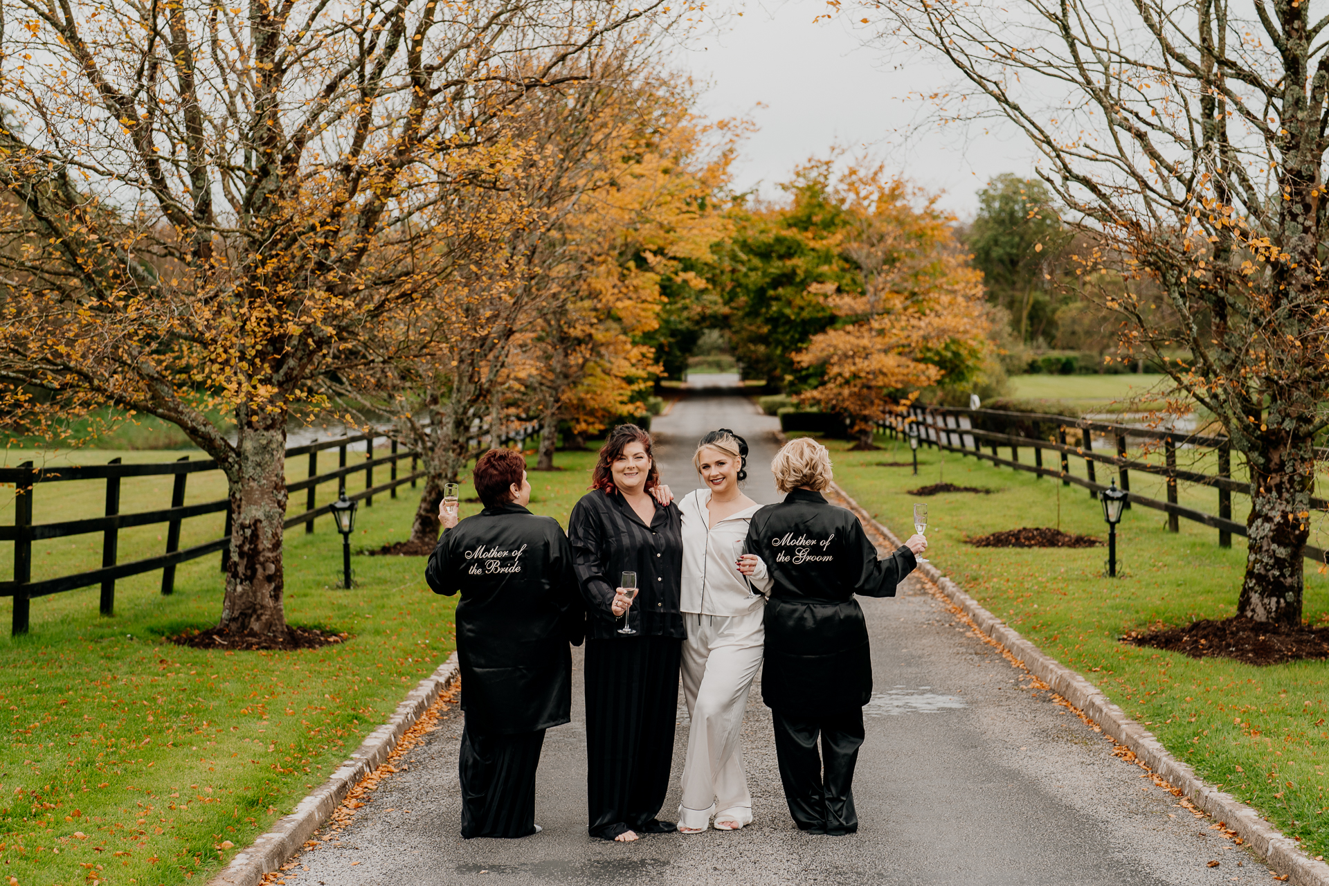 A group of people posing for a photo on a path in a park