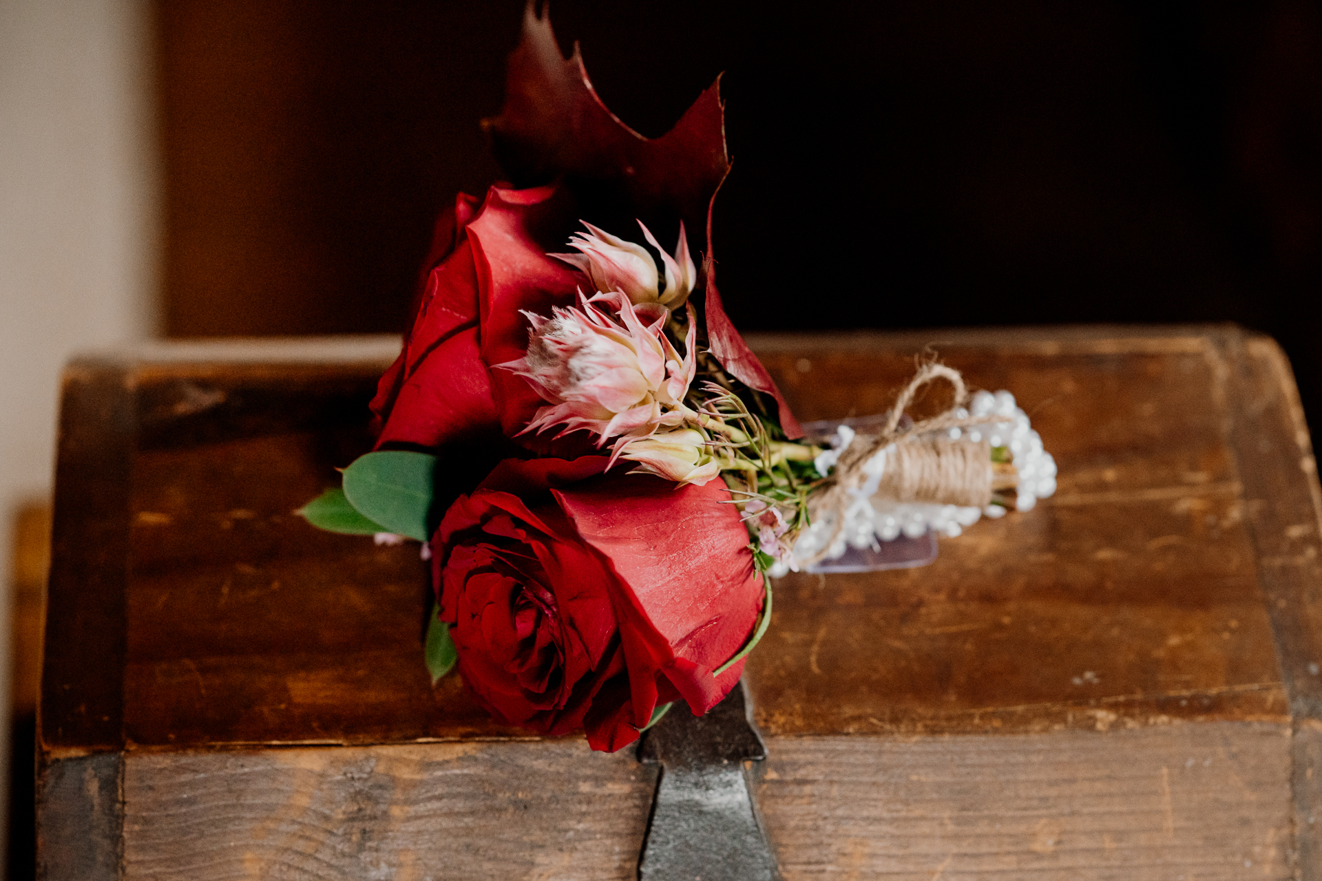 A person in a red dress holding flowers