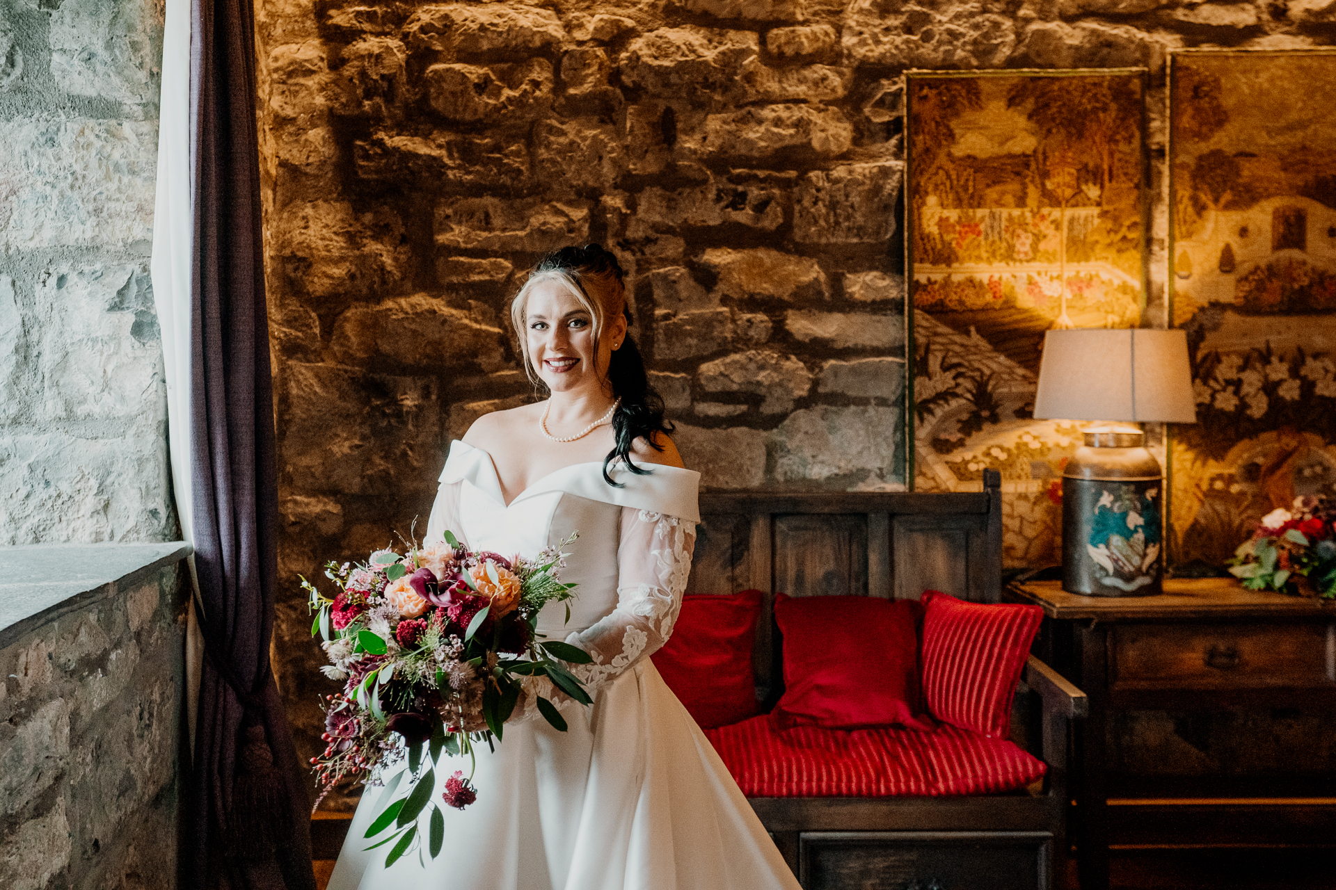 A person in a white dress holding a bouquet of flowers