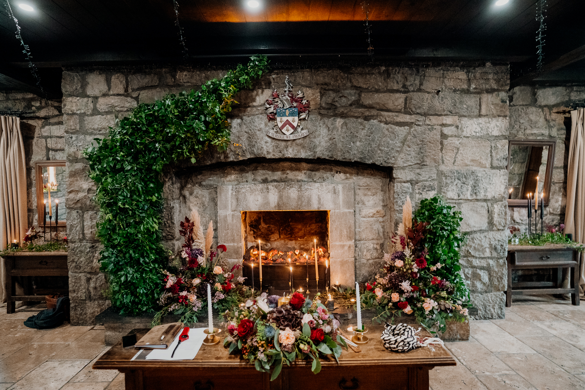 A fireplace with flowers and plants