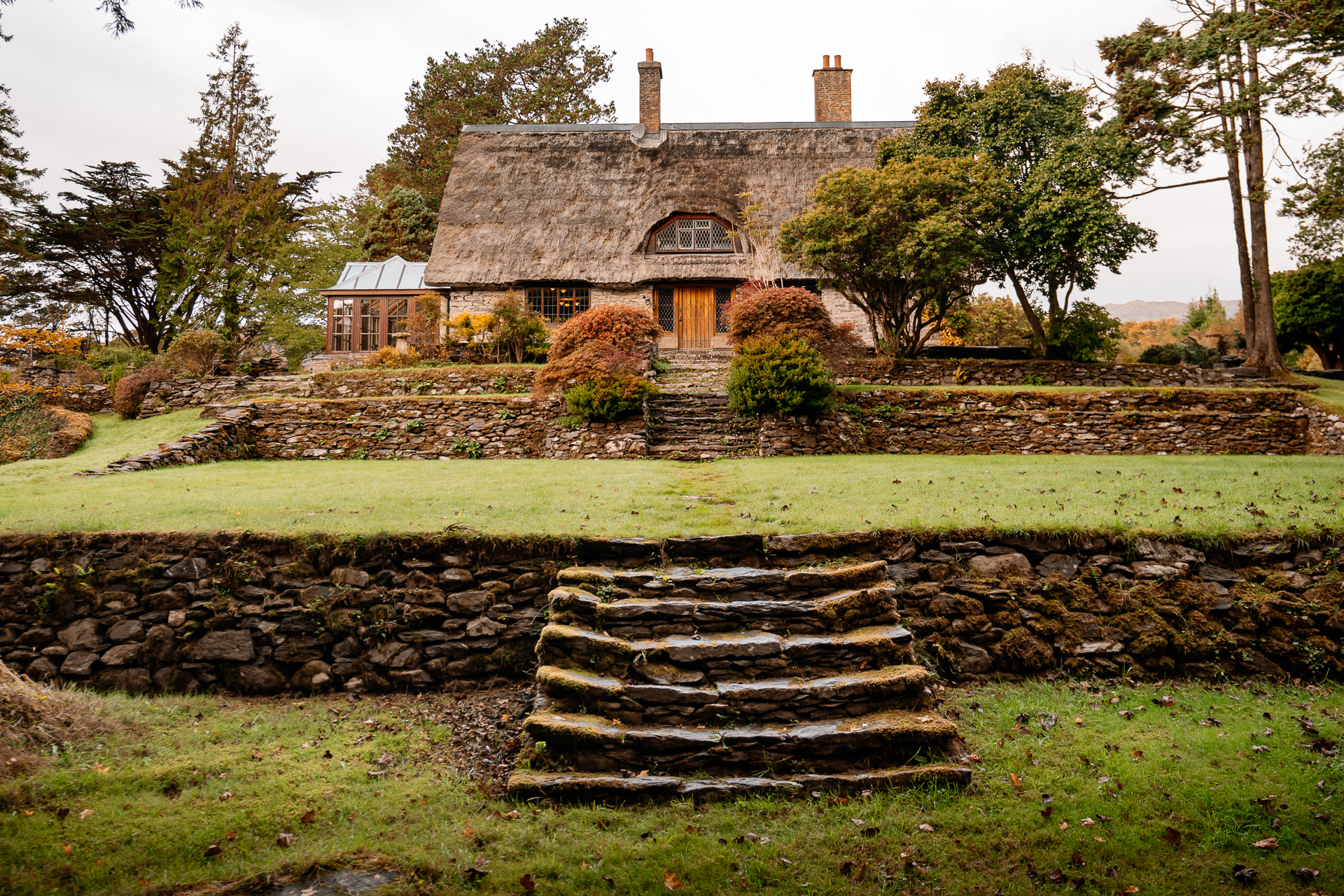 A stone wall in front of a house