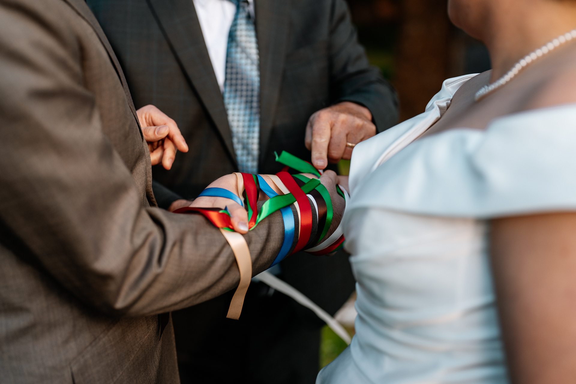 A man and woman holding a colorful string