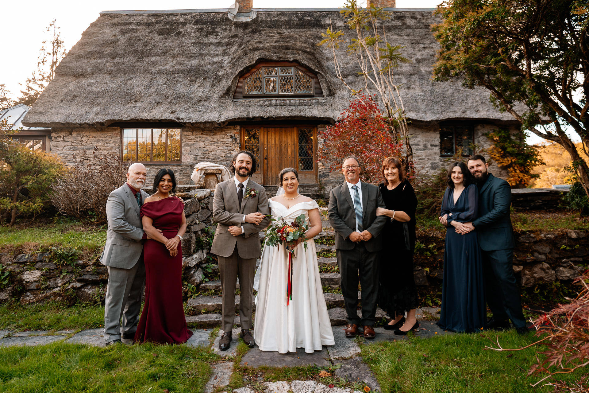 A group of people posing for a photo in front of a house