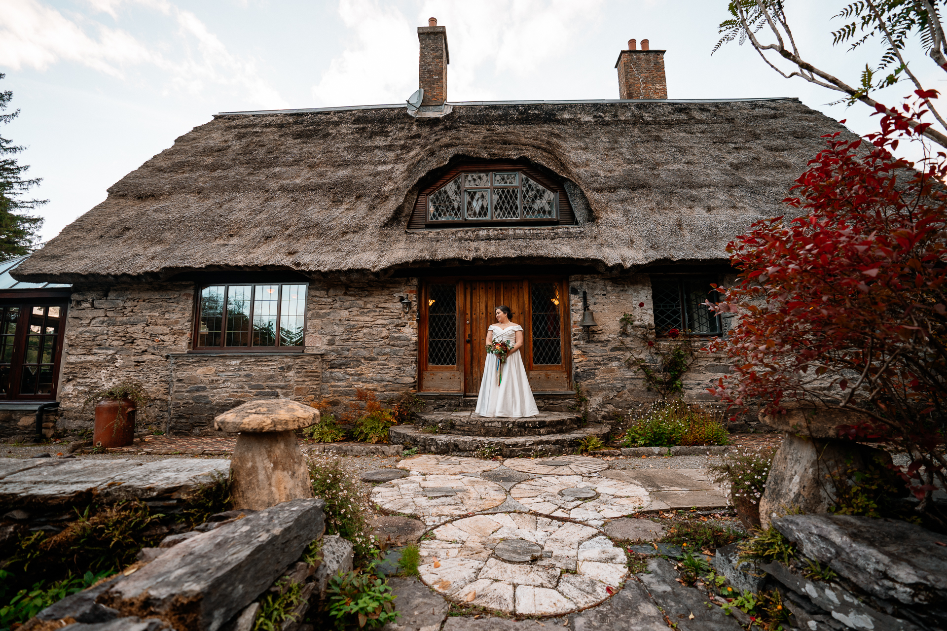 A bride and groom in front of a house