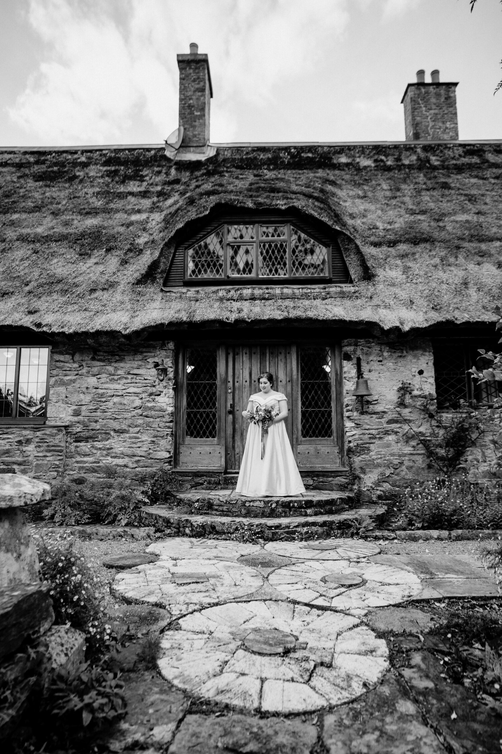 A person standing in front of a stone building