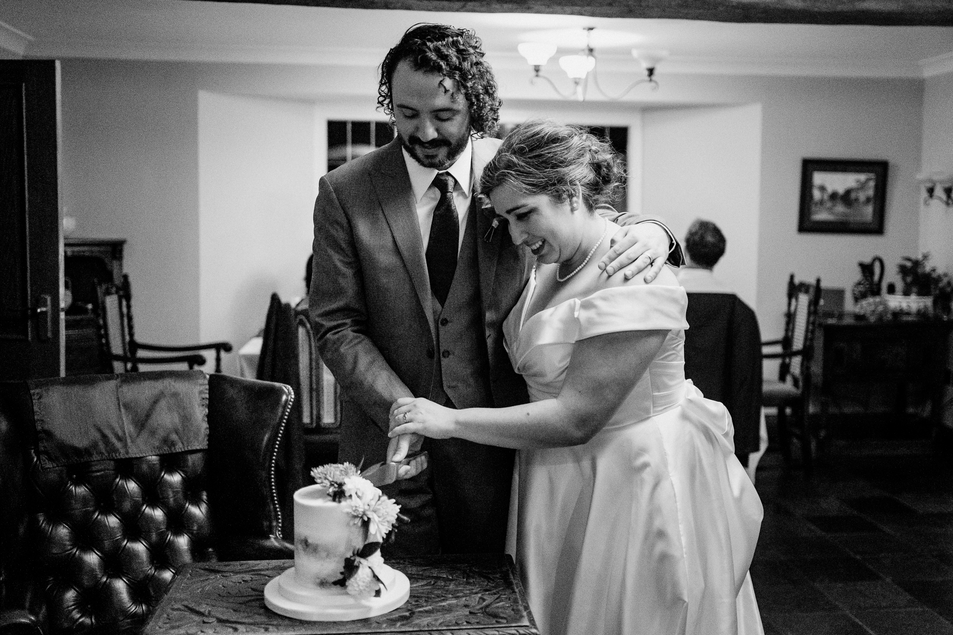 A bride and groom cutting a cake