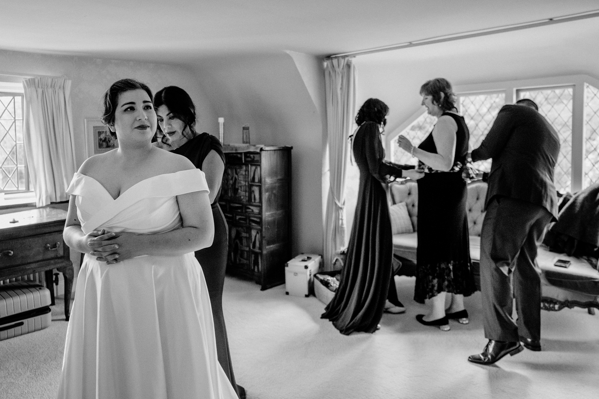 A person in a wedding dress dancing in a room with other people