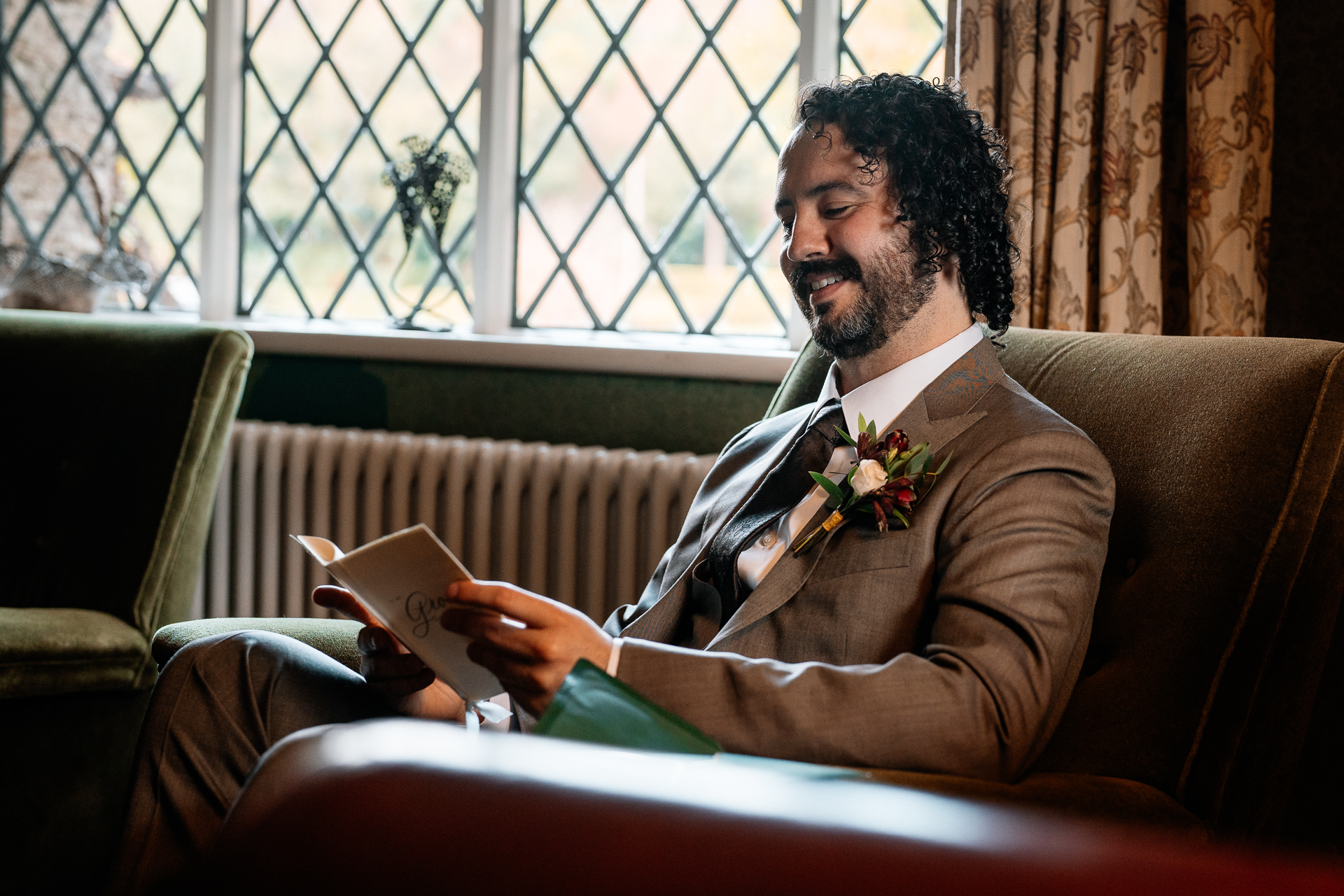 A man sitting on a couch reading a book