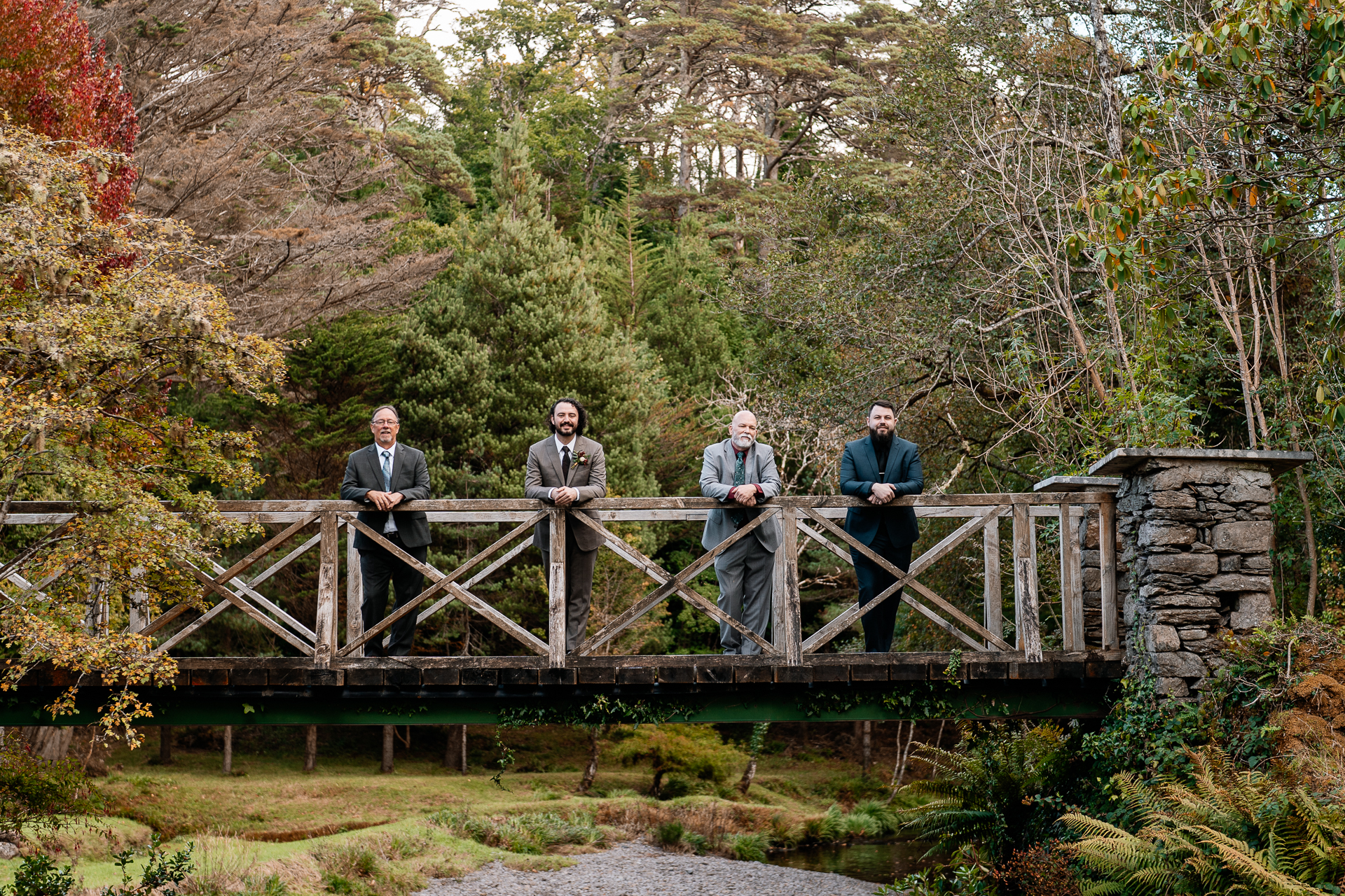 A group of people standing on a bridge over a river