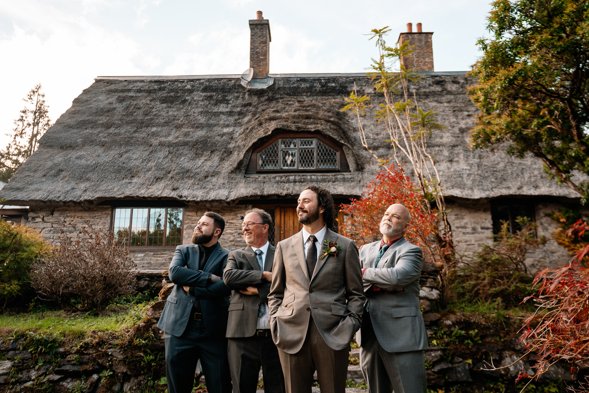 A group of men standing in front of a house