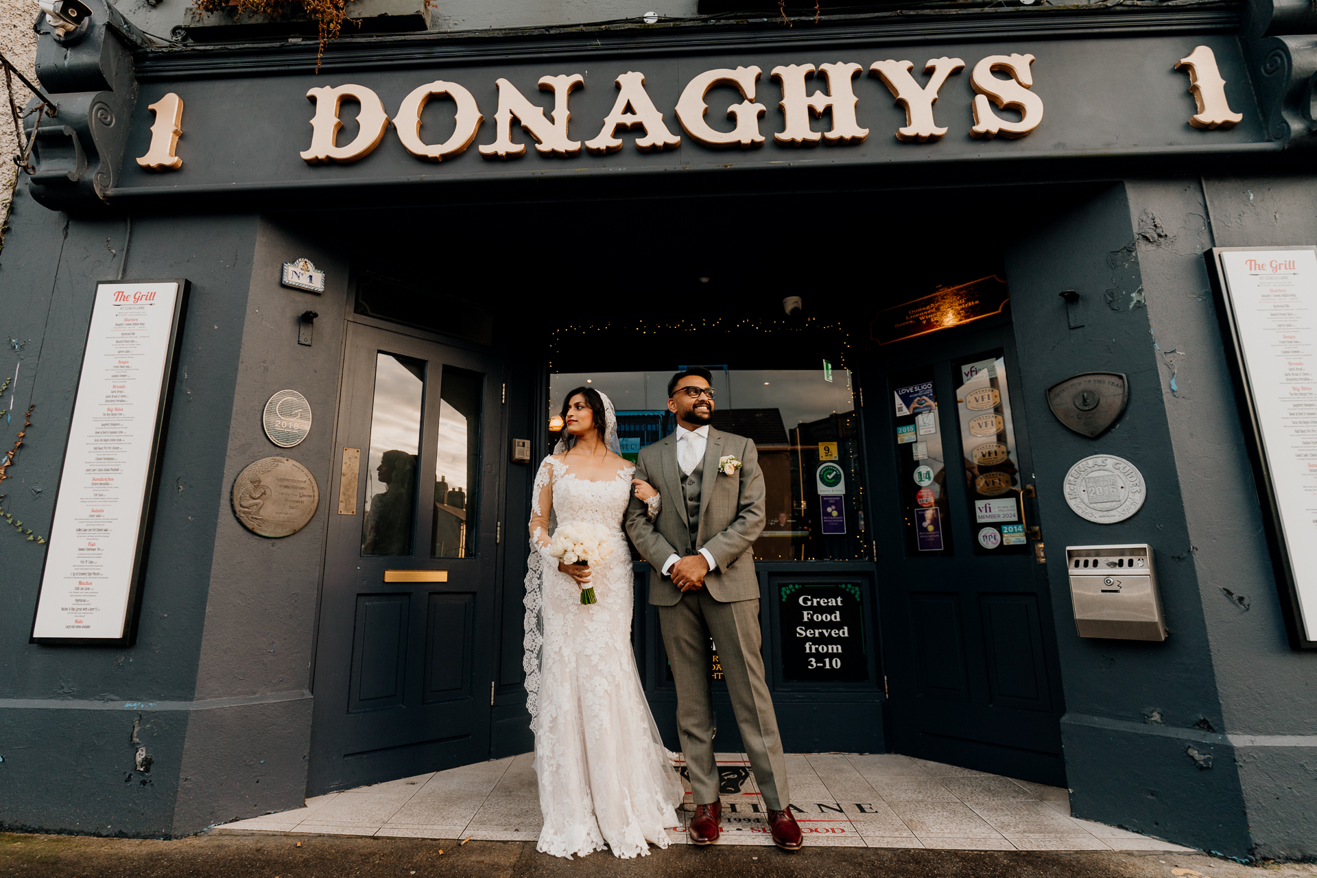 A man and woman posing for a picture in front of a store