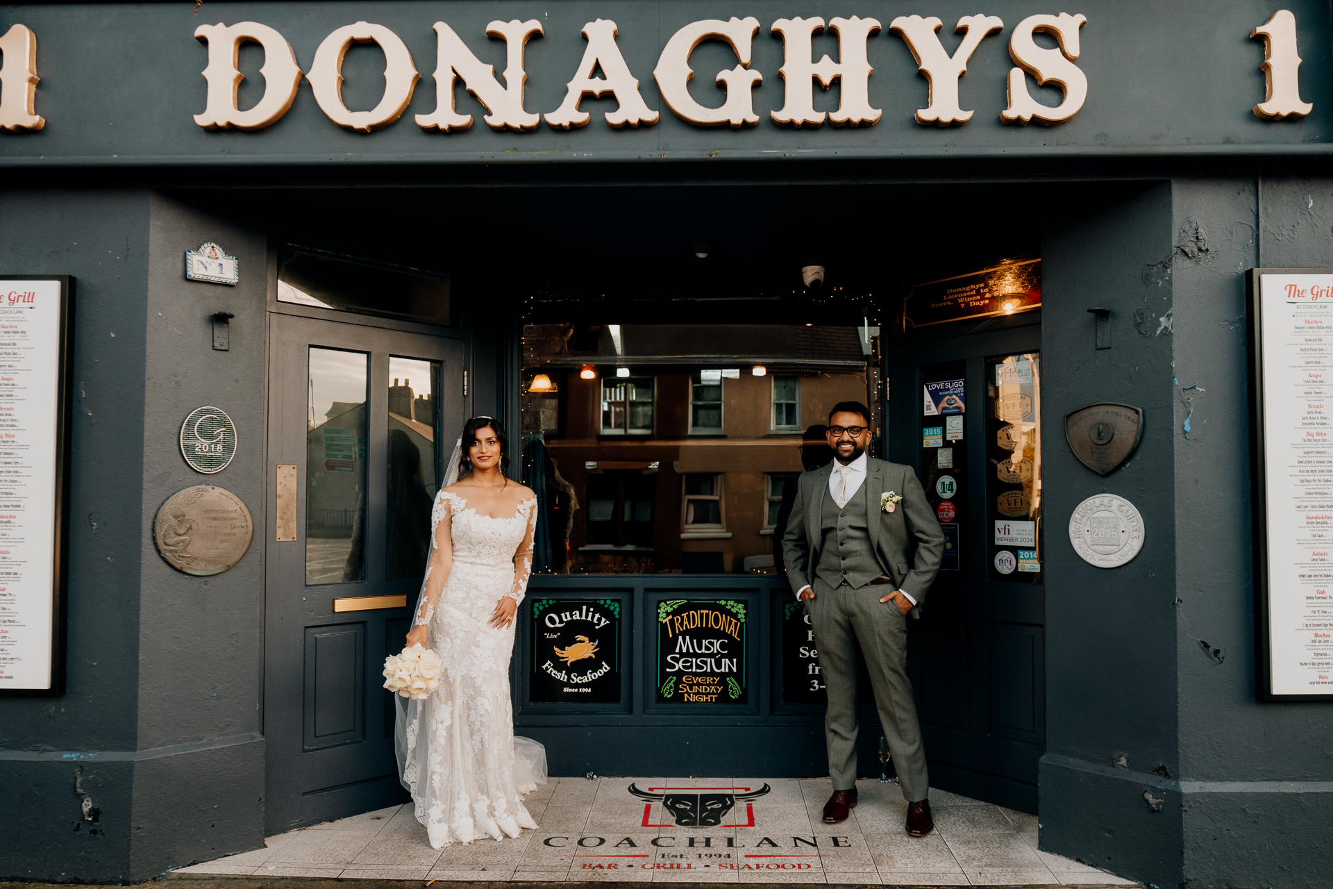 A man and woman posing for a picture in front of a store