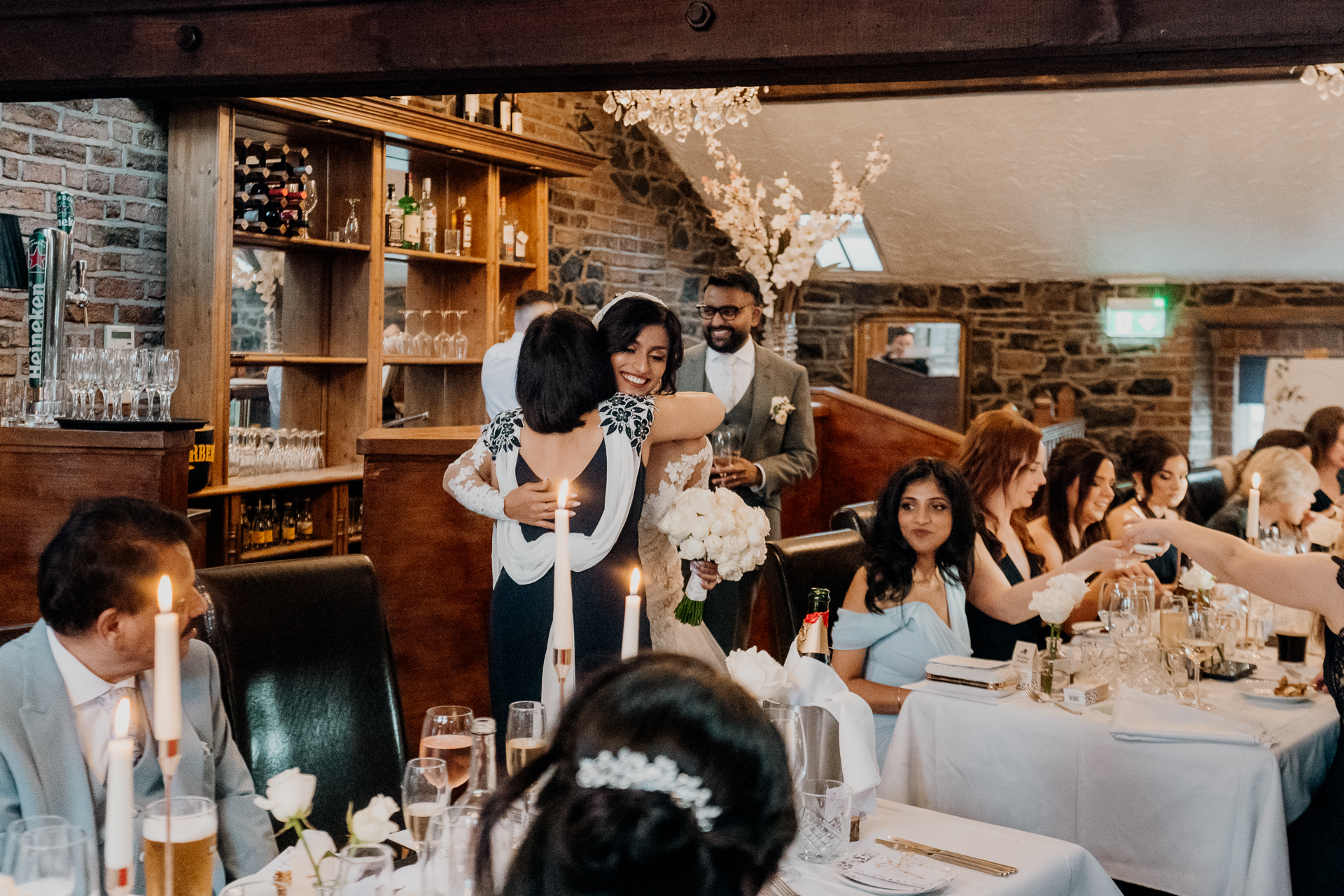 A group of people sitting at a table with food and drinks