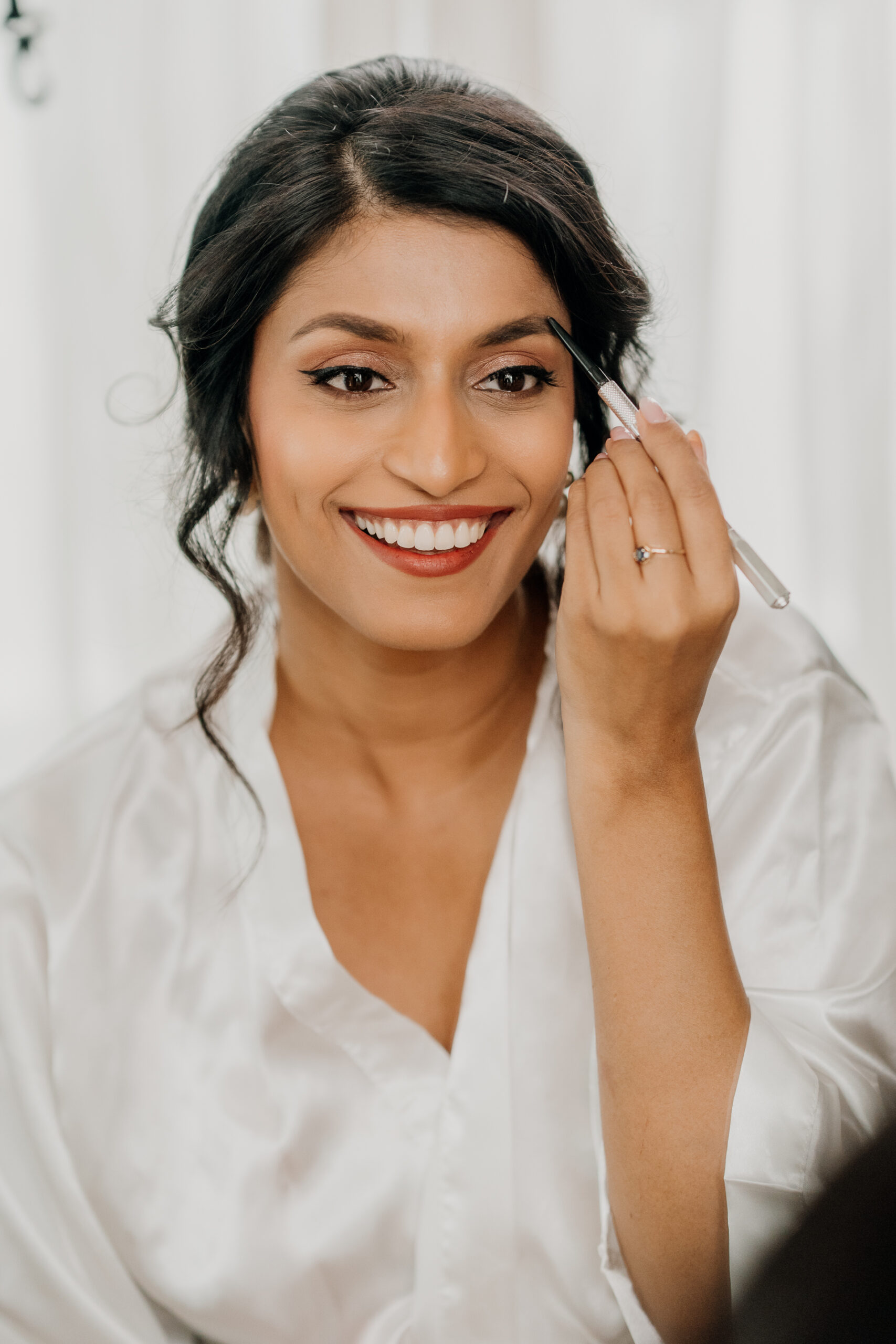 A woman smiling and holding a phone