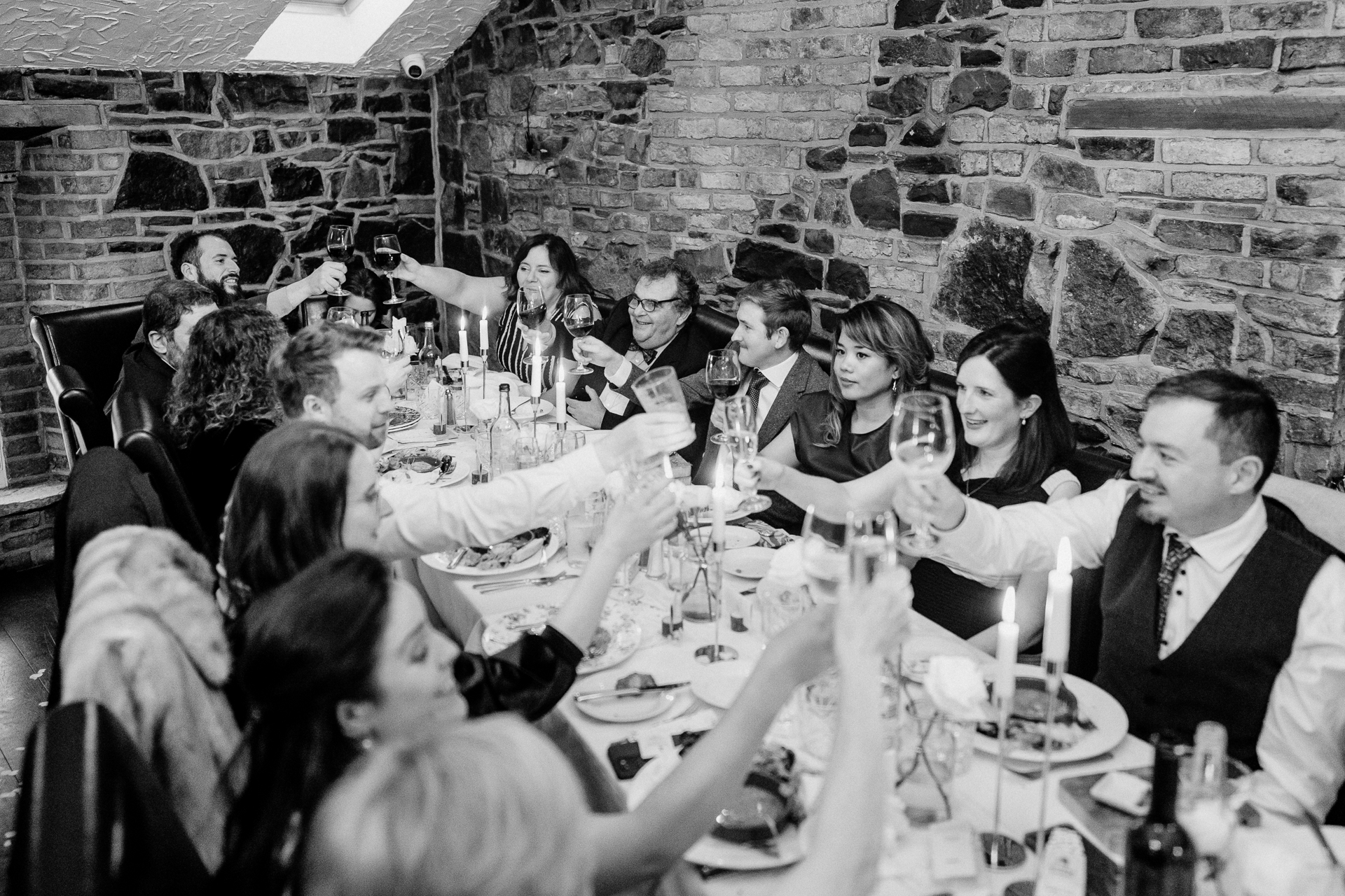 A group of people sitting around a table with food and drinks