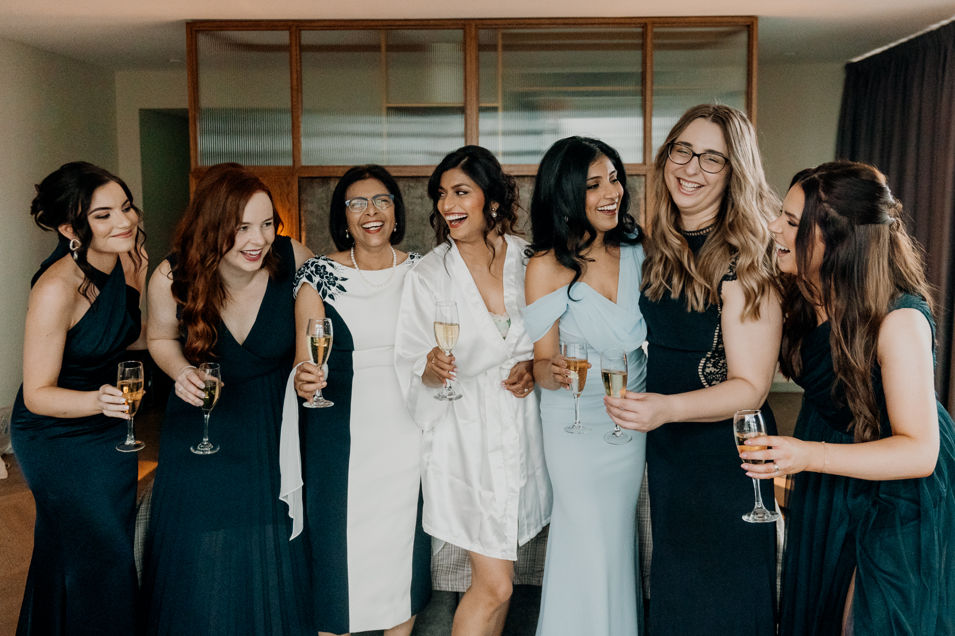 A group of women holding wine glasses