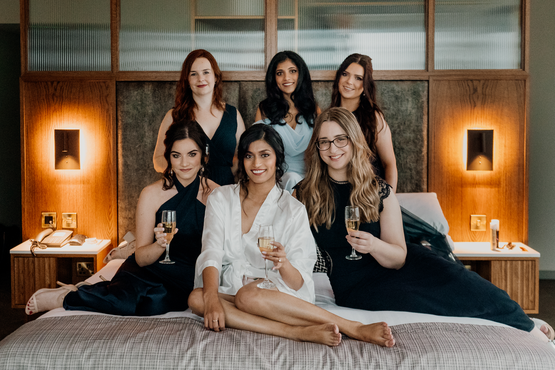 A group of women holding wine glasses