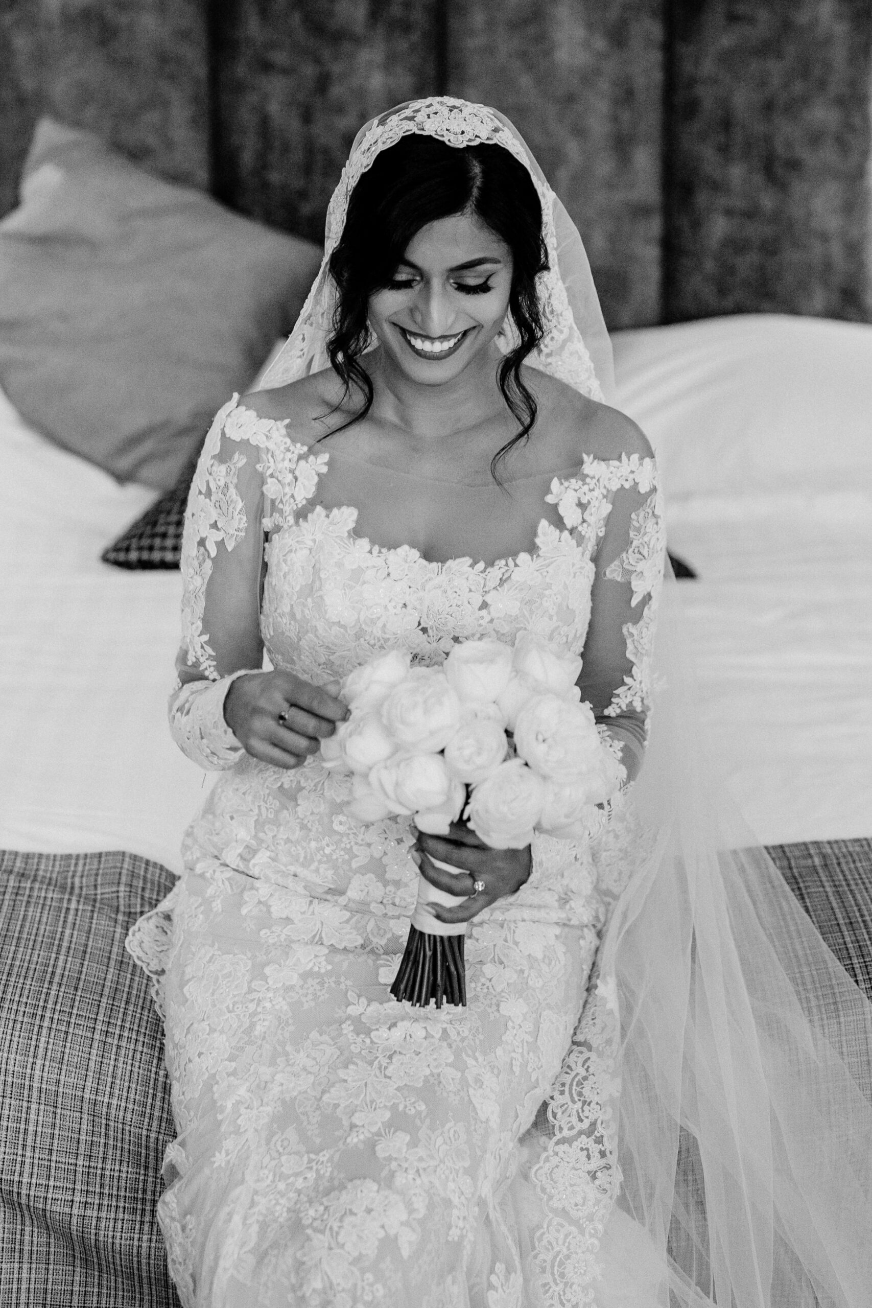 A woman in a wedding dress holding a bouquet of flowers