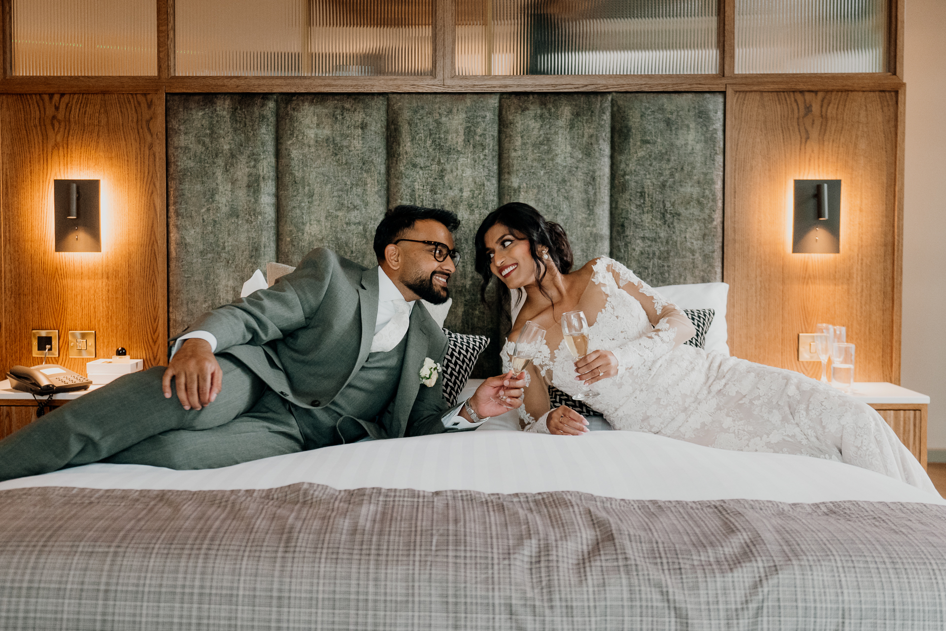 A man and woman sitting on a bed