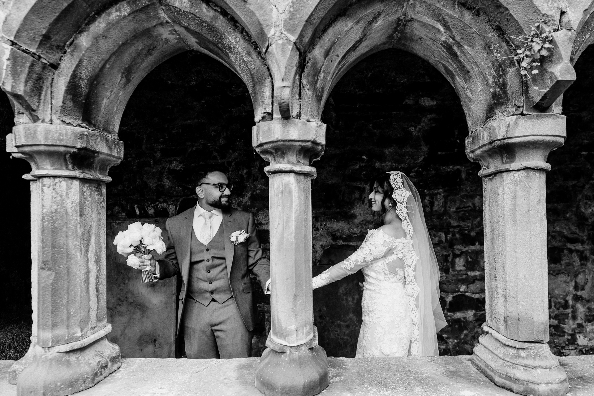 A bride and groom standing in front of a building