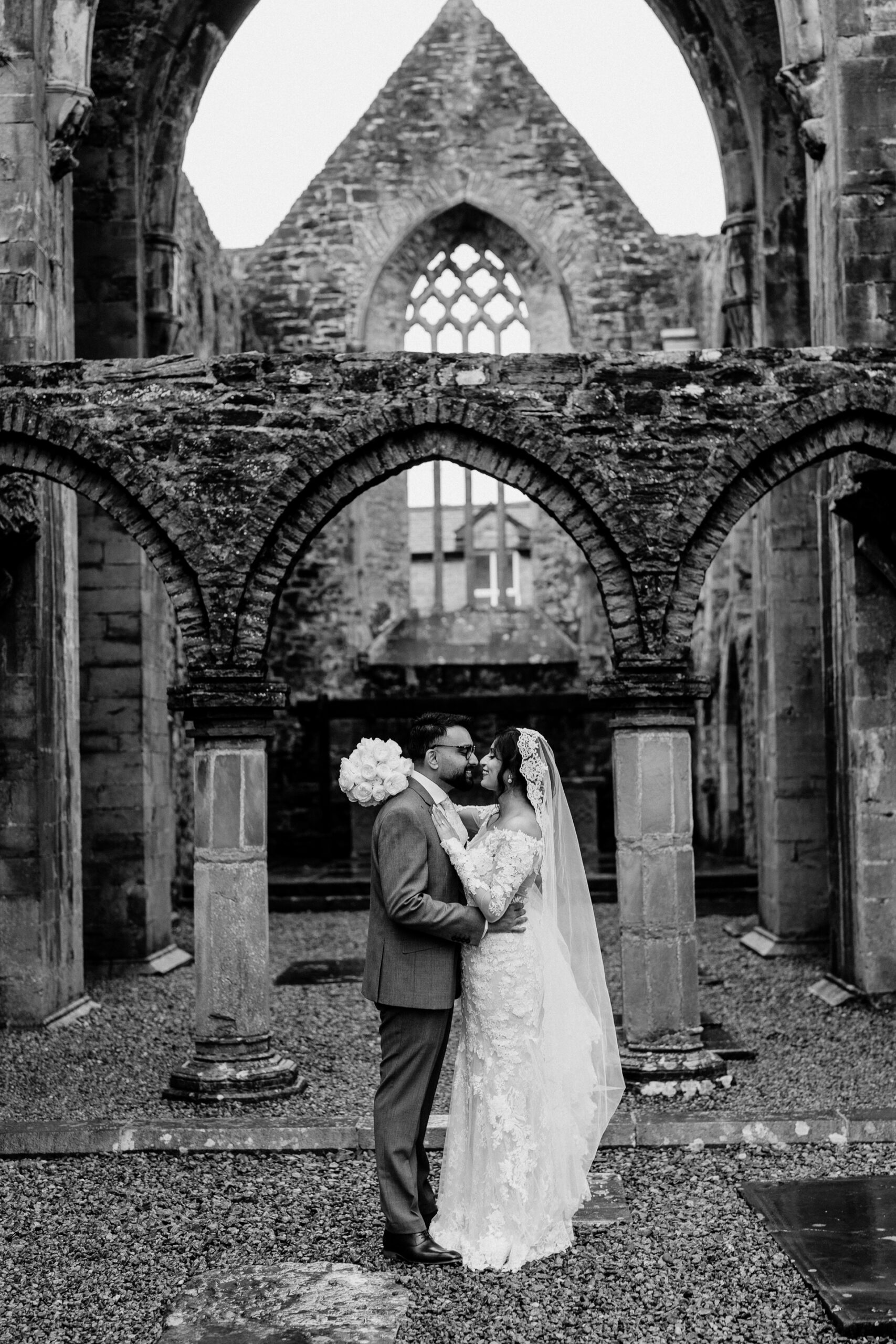 A man and woman kissing in front of a building