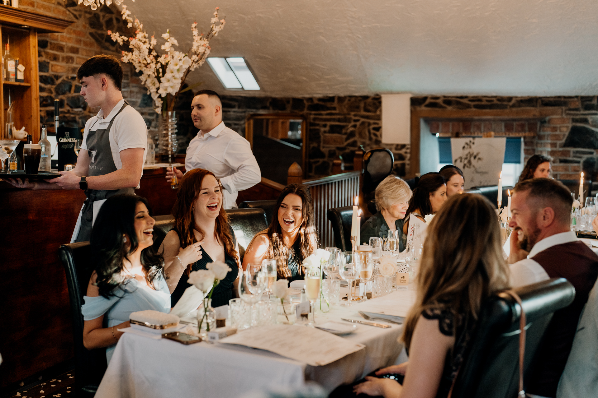 A group of people sitting at a table with wine glasses