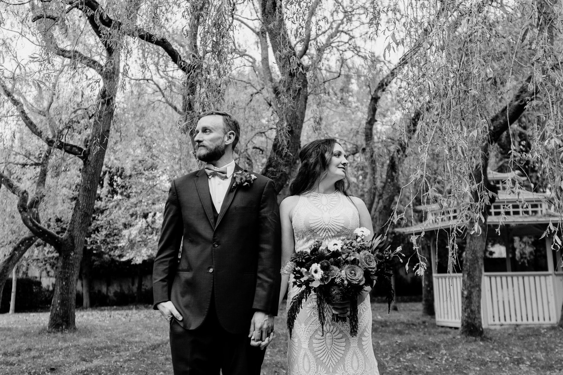 A man and woman walking down a path with trees and grass