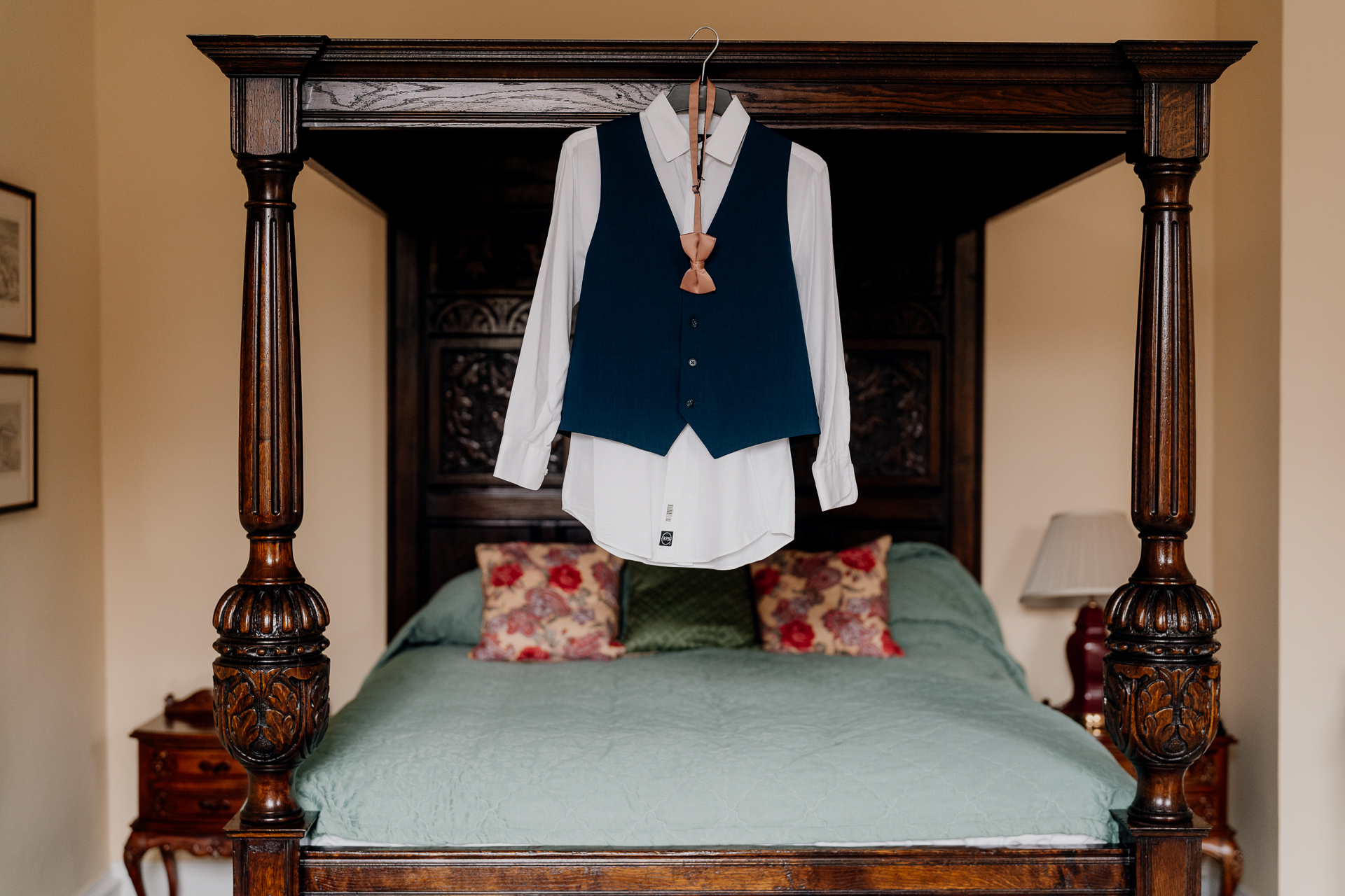 A bed with a blue and white shirt from a wood frame