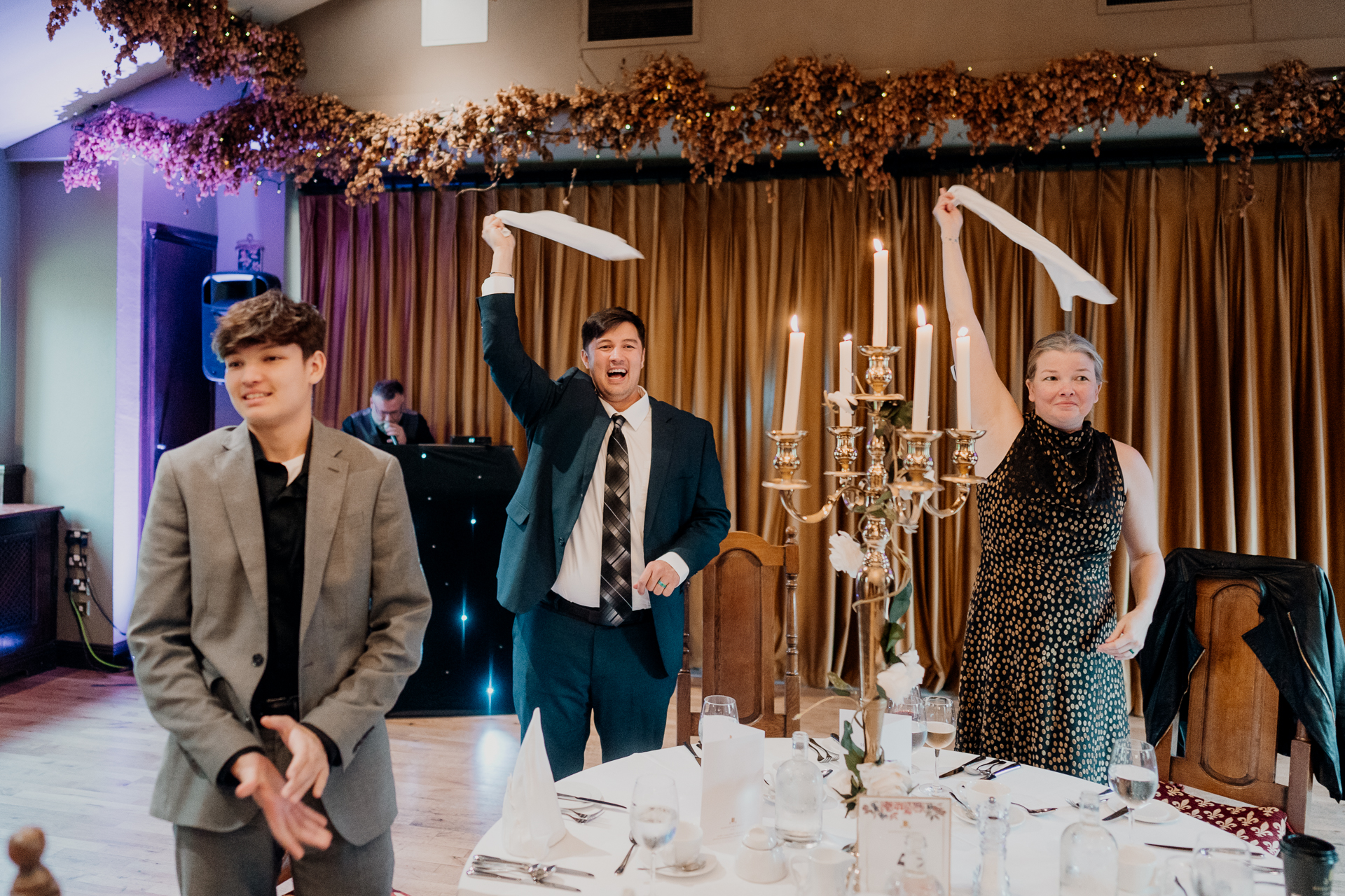 A group of people standing in front of a table with food and drinks