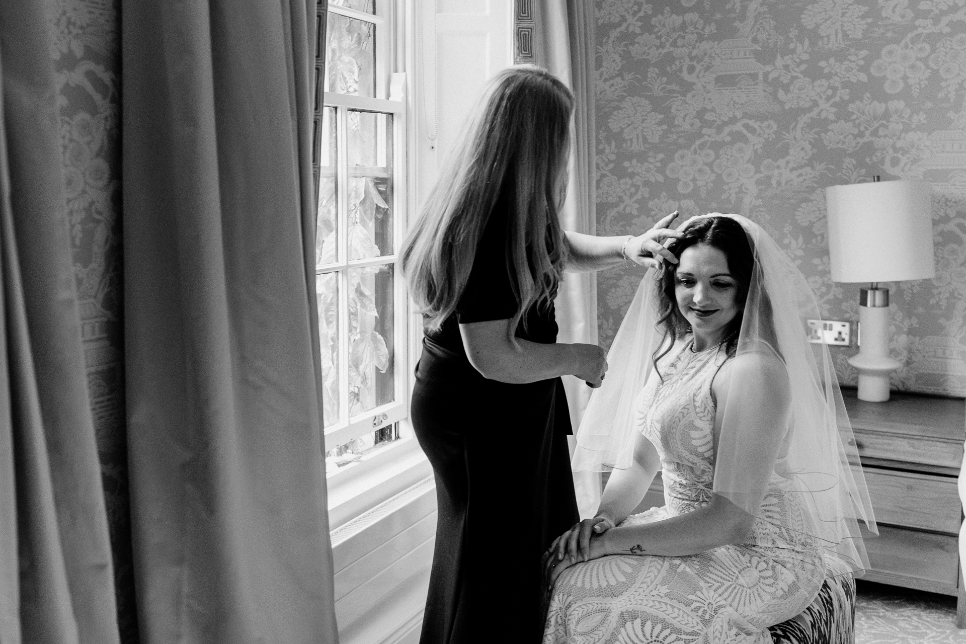 A woman in a dress and a woman in a dress in a room