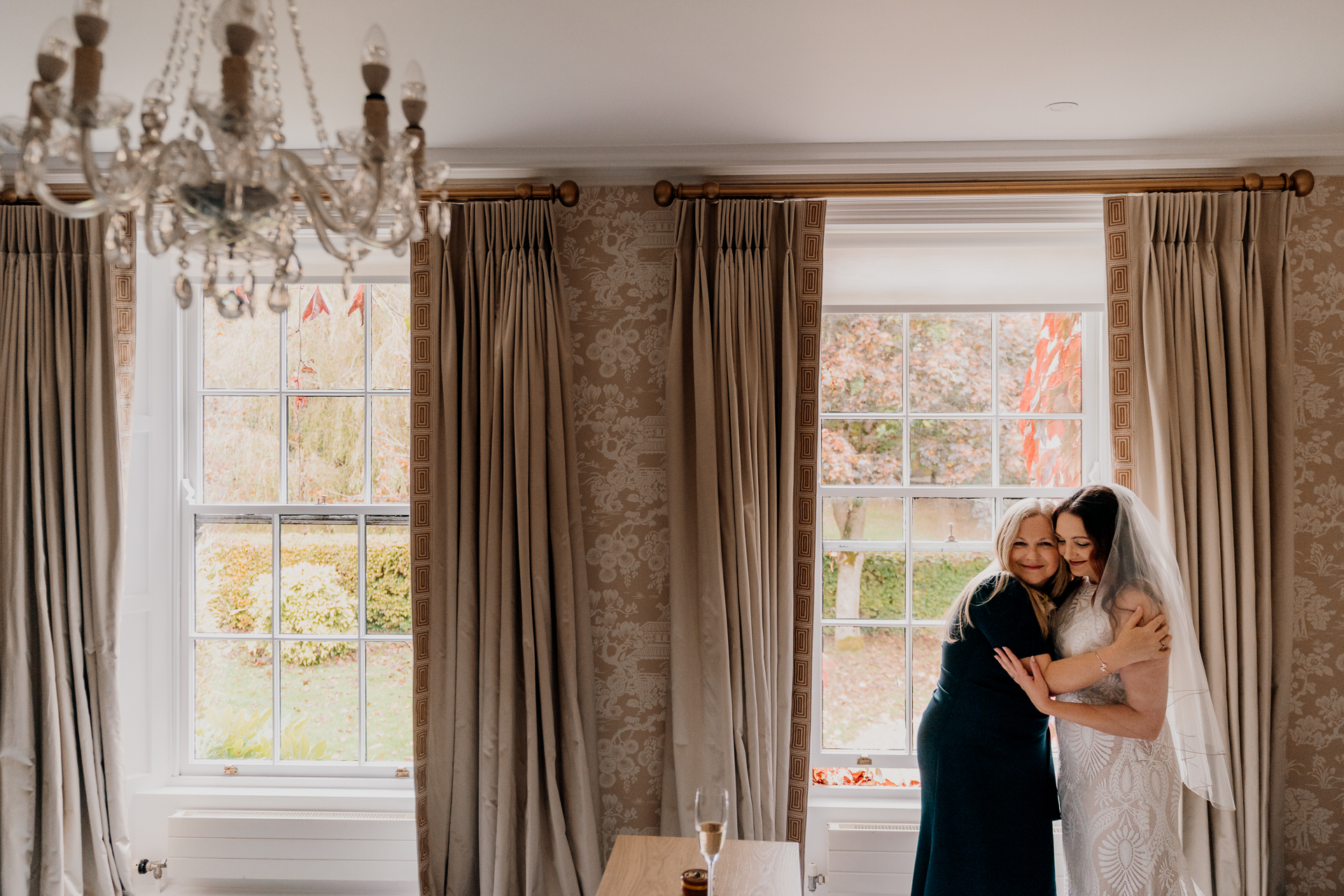 A woman kissing a man in a room with curtains and windows