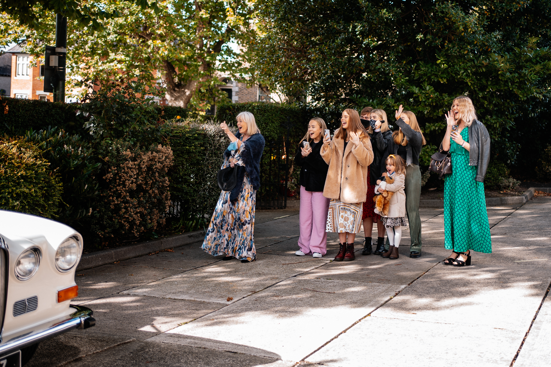 A group of women standing on a sidewalk