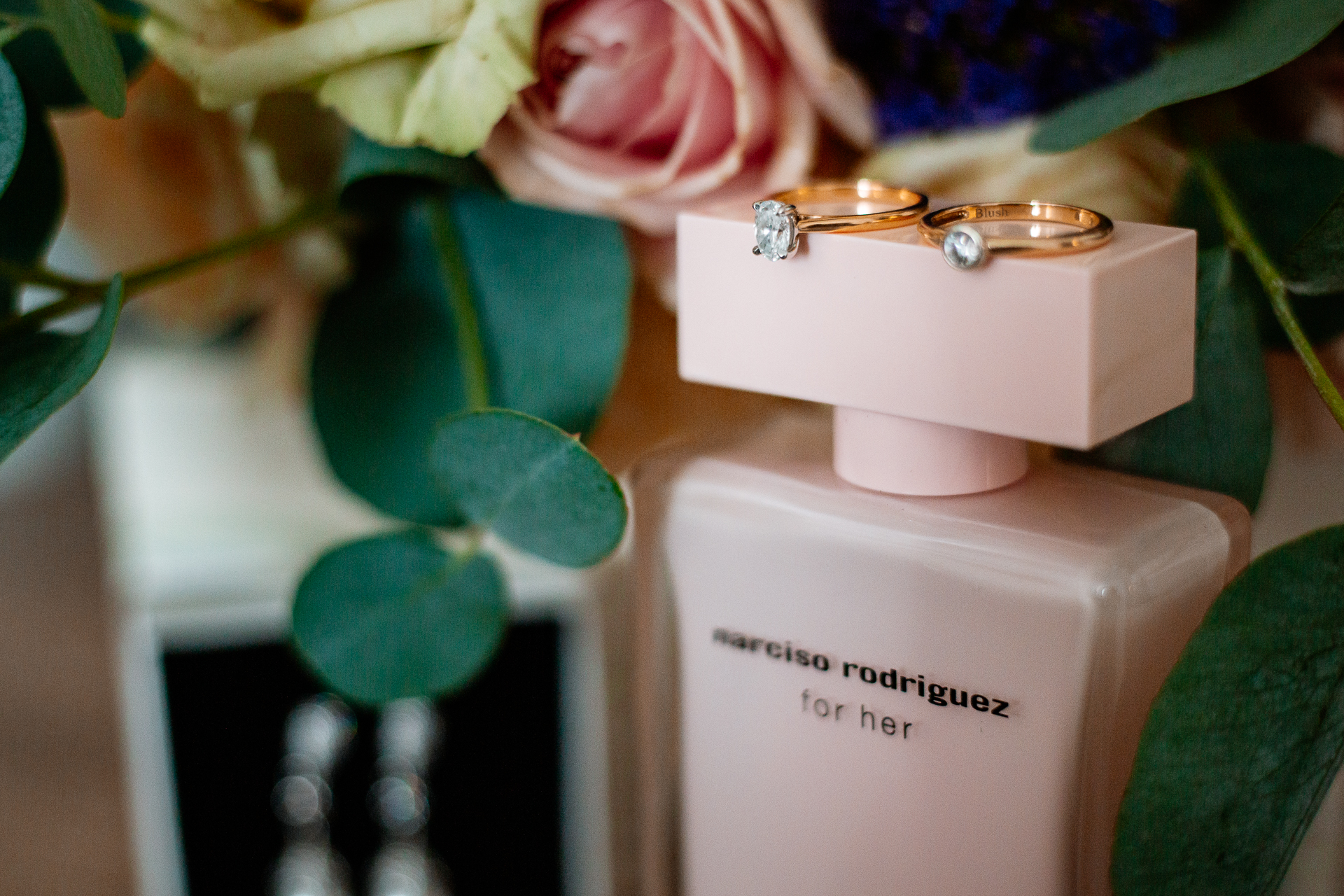 A white box with a gold ring on top of a white box