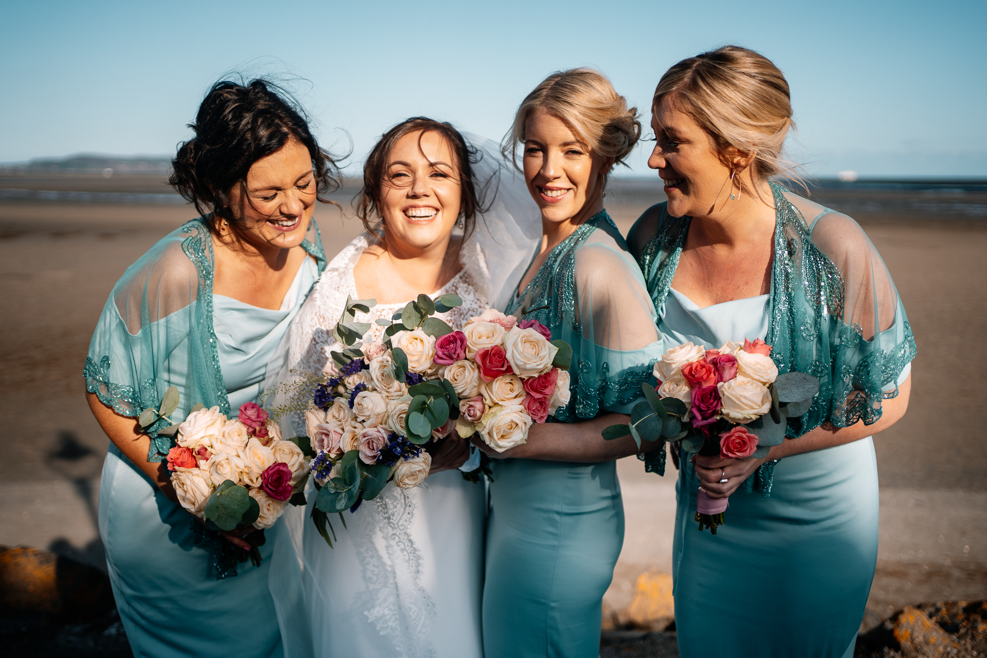 A group of women in dresses holding flowers