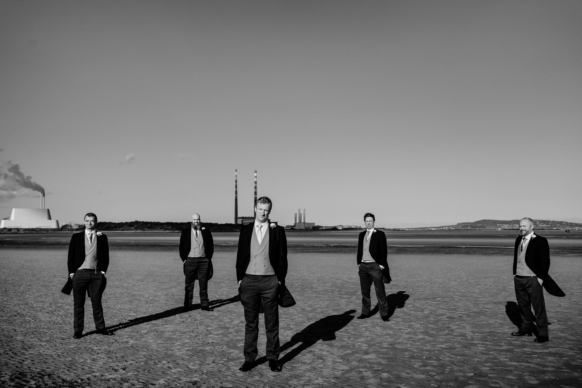 A group of men walking on a concrete surface