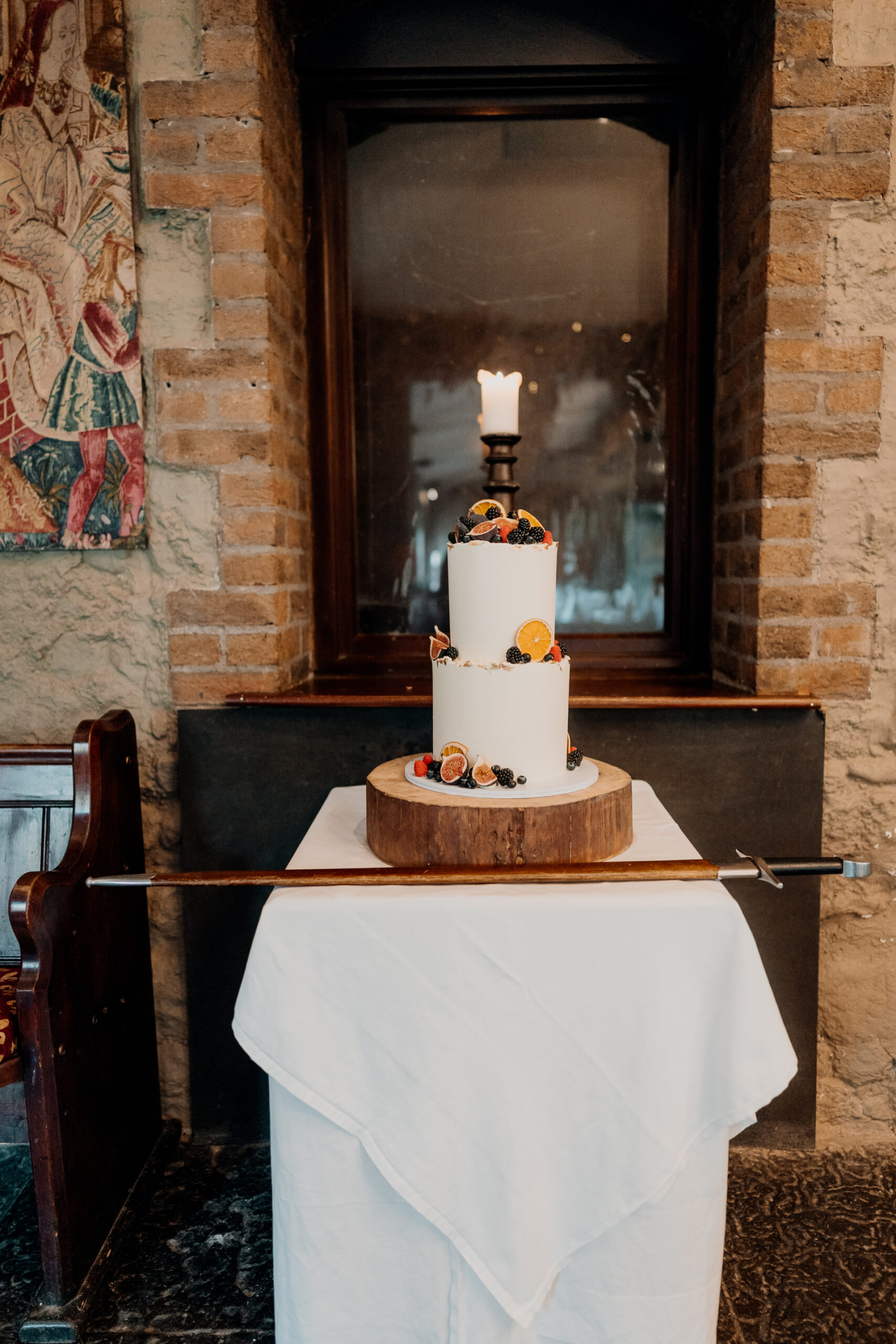 A white vase with candles on a table