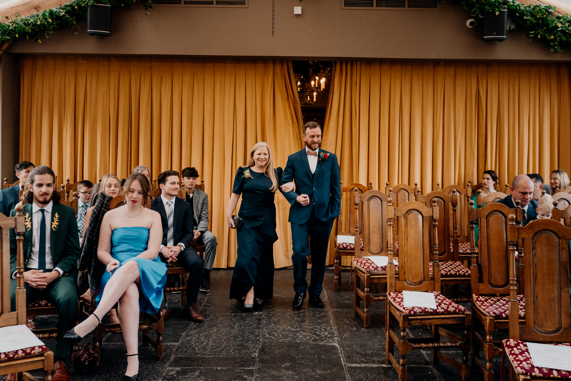 A man and woman standing in front of a group of people sitting in chairs