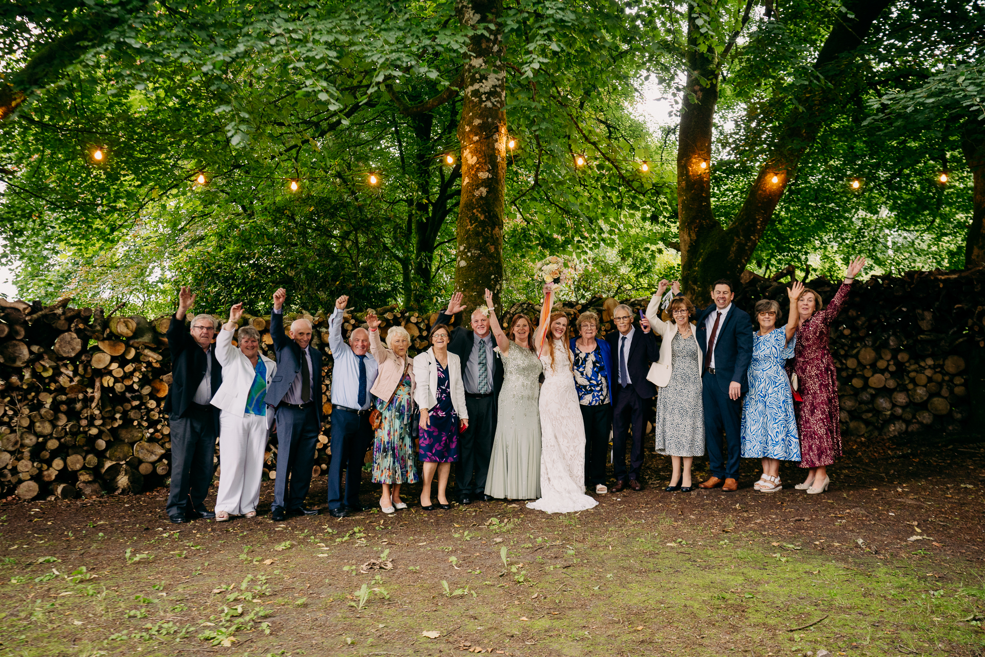 A group of people posing for a photo under a tree