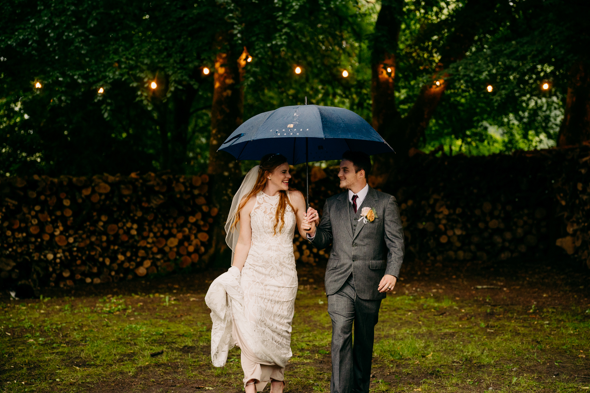 A man and woman walking under an umbrella