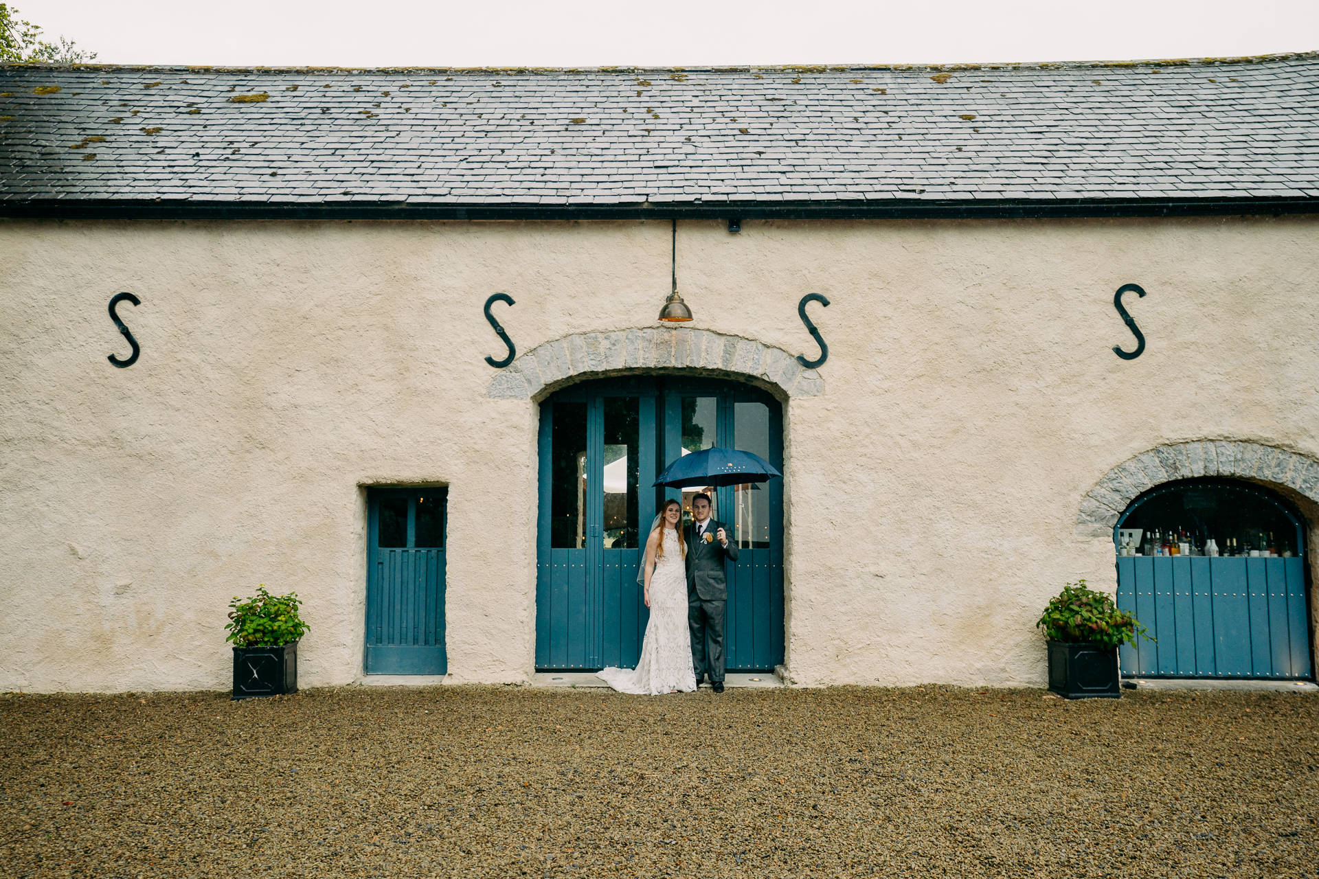 A bride and groom standing in front of a building