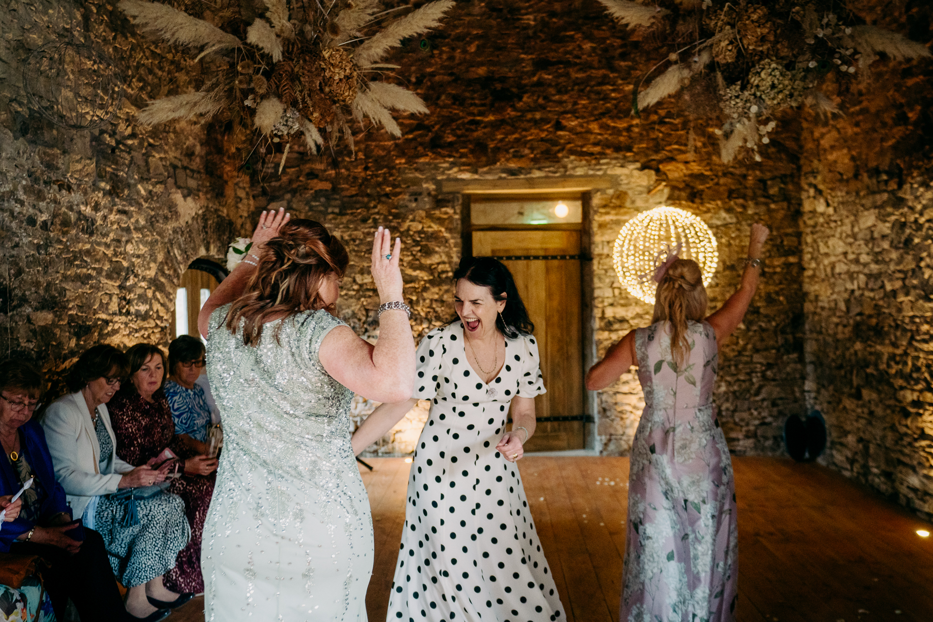 A group of women in dresses dancing