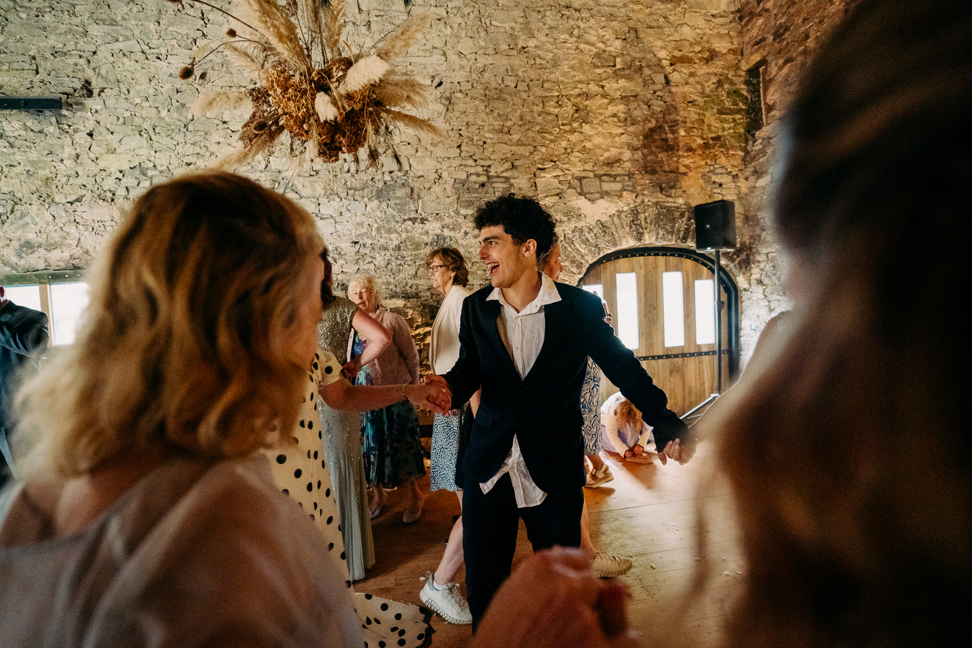 A man in a suit dancing with a woman in a dress