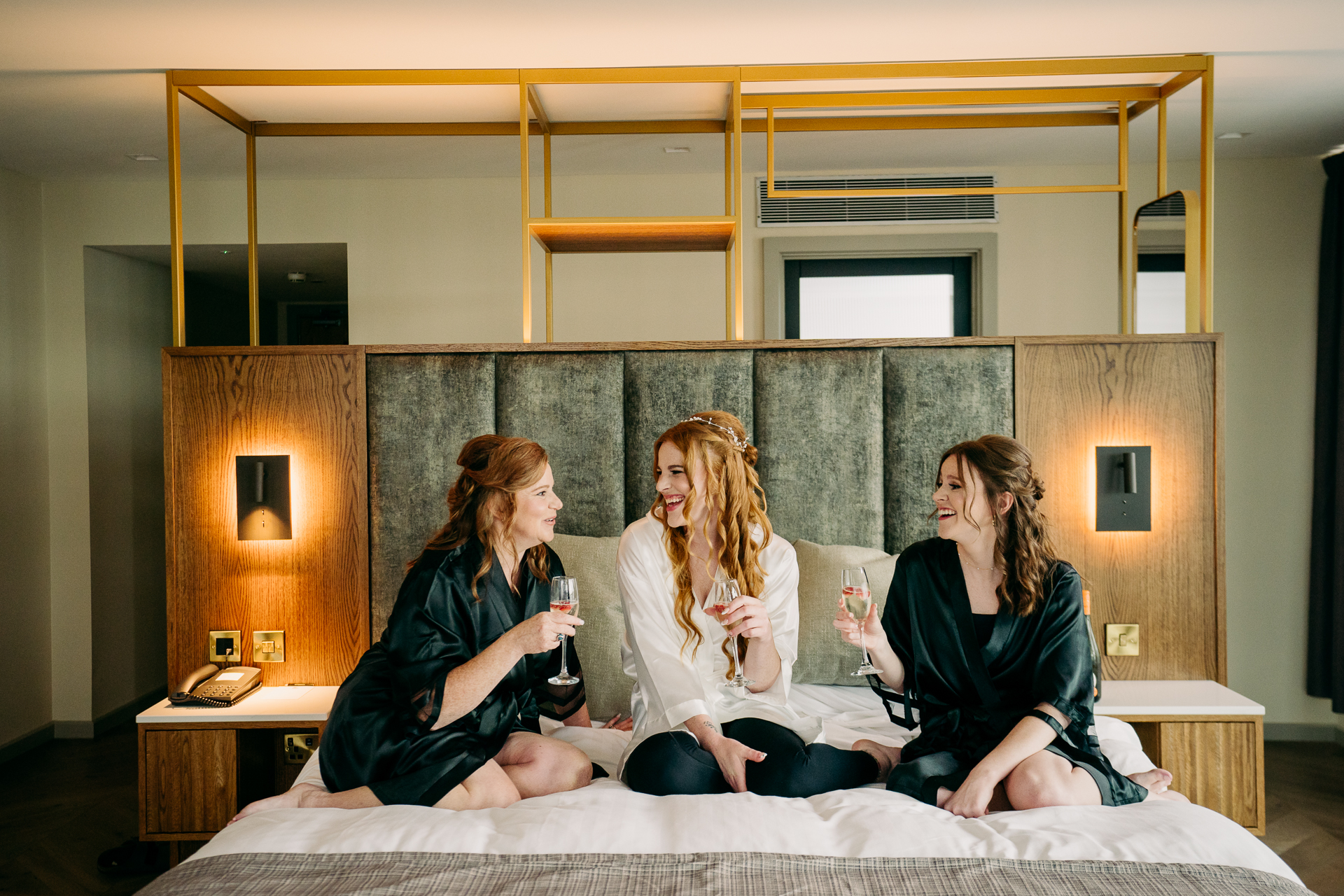 A group of women sitting on a bed